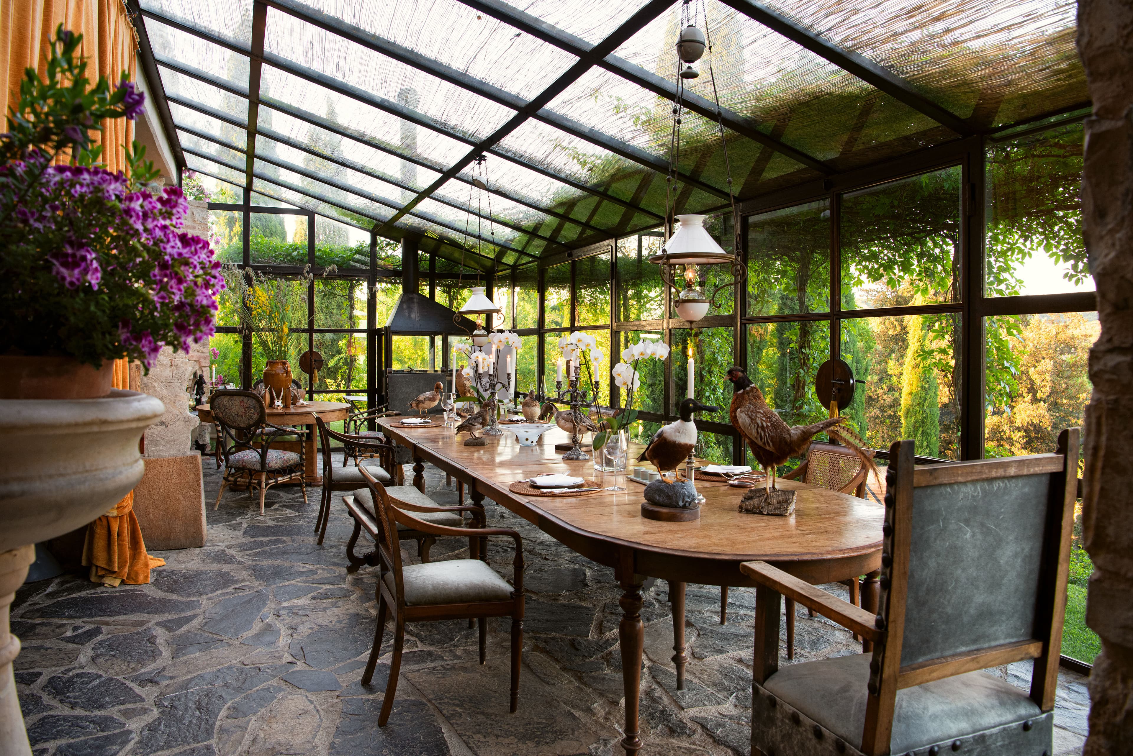 Villa Fortaleza glass conservatory lounge with yellow velvet sofa, Province of Grosseto, Tuscany