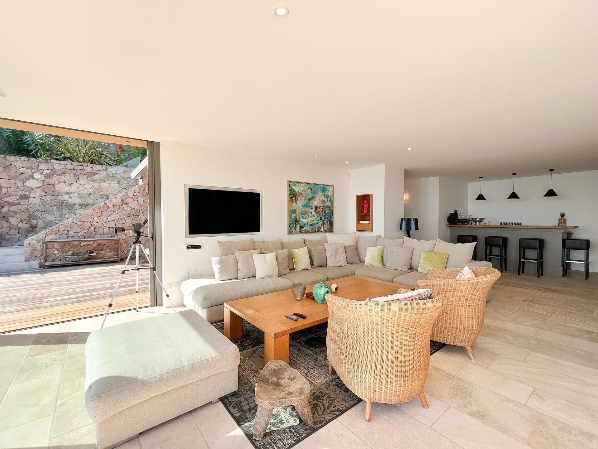 Lounge with a breakfast bar and stools open to the living area at Coastal Azure, Theoule-sur-Mer