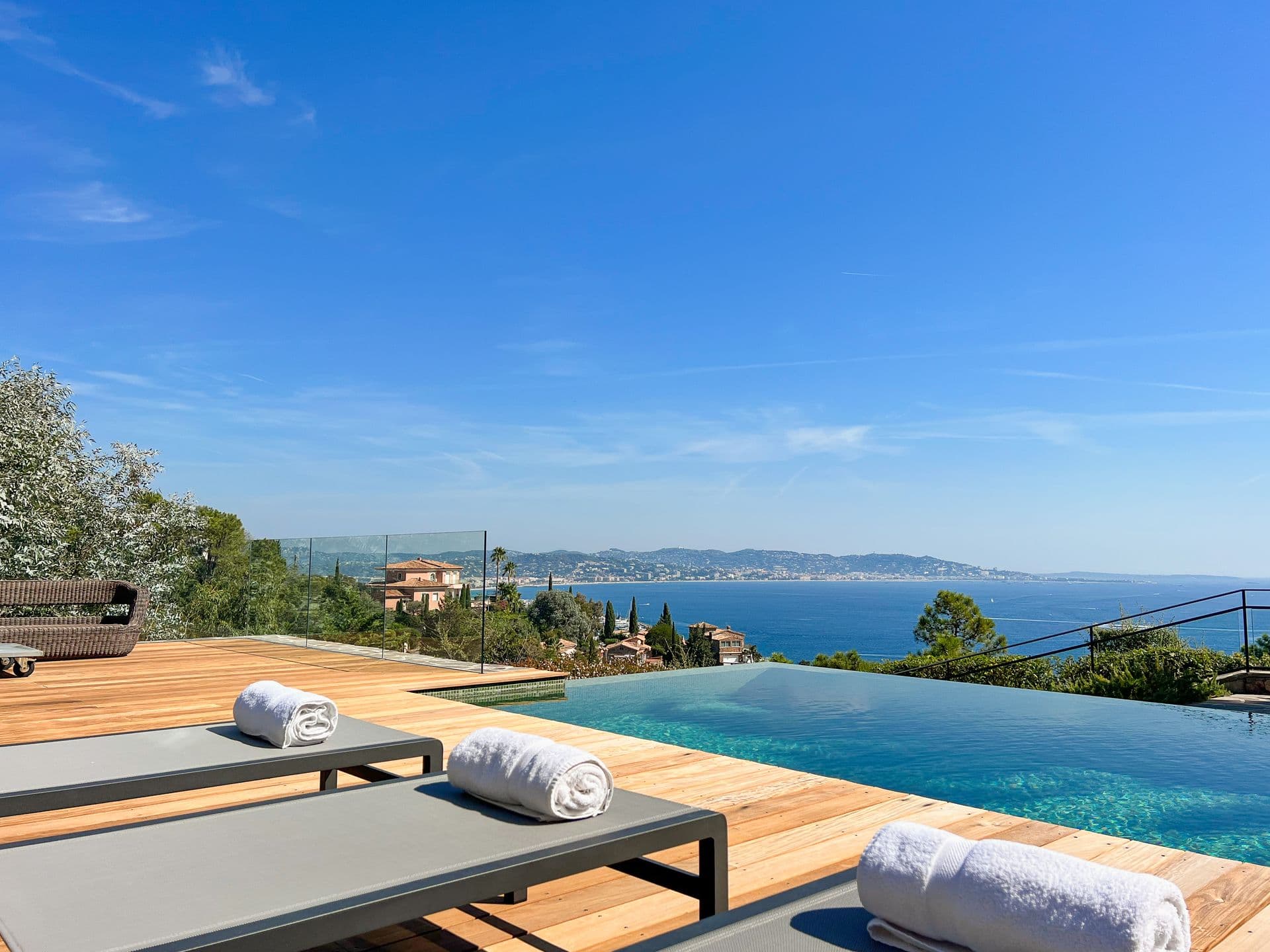 Infinity pool and loungers looking across the bay toward Cannes at Coastal Azure, Theoule-sur-Mer