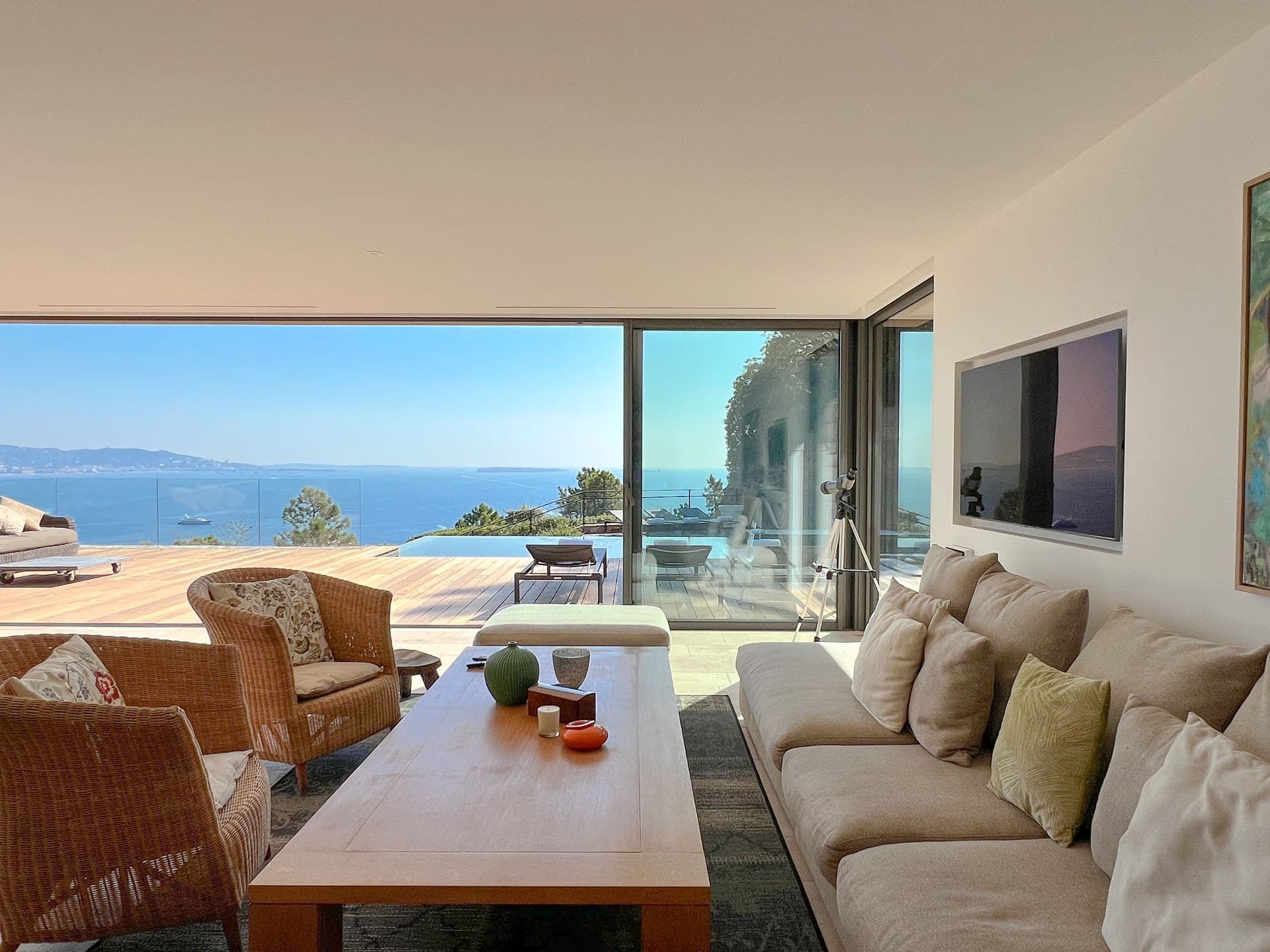 Living room with cream sofas opening to the sea-view terrace at Coastal Azure, Theoule-sur-Mer