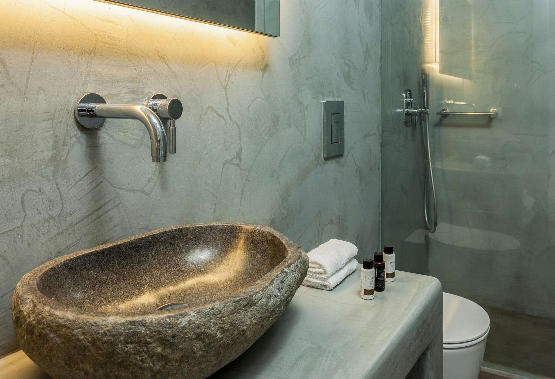 Marble shower room with a stone basin and concealed lighting at Ancient Azure Vistas, Mykonos