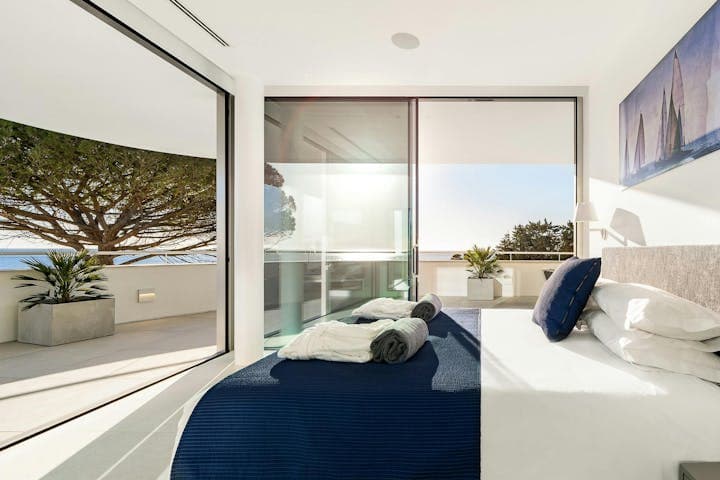 Atlantic Blues master bedroom with glass walls and ocean terrace, Lagos, Portugal