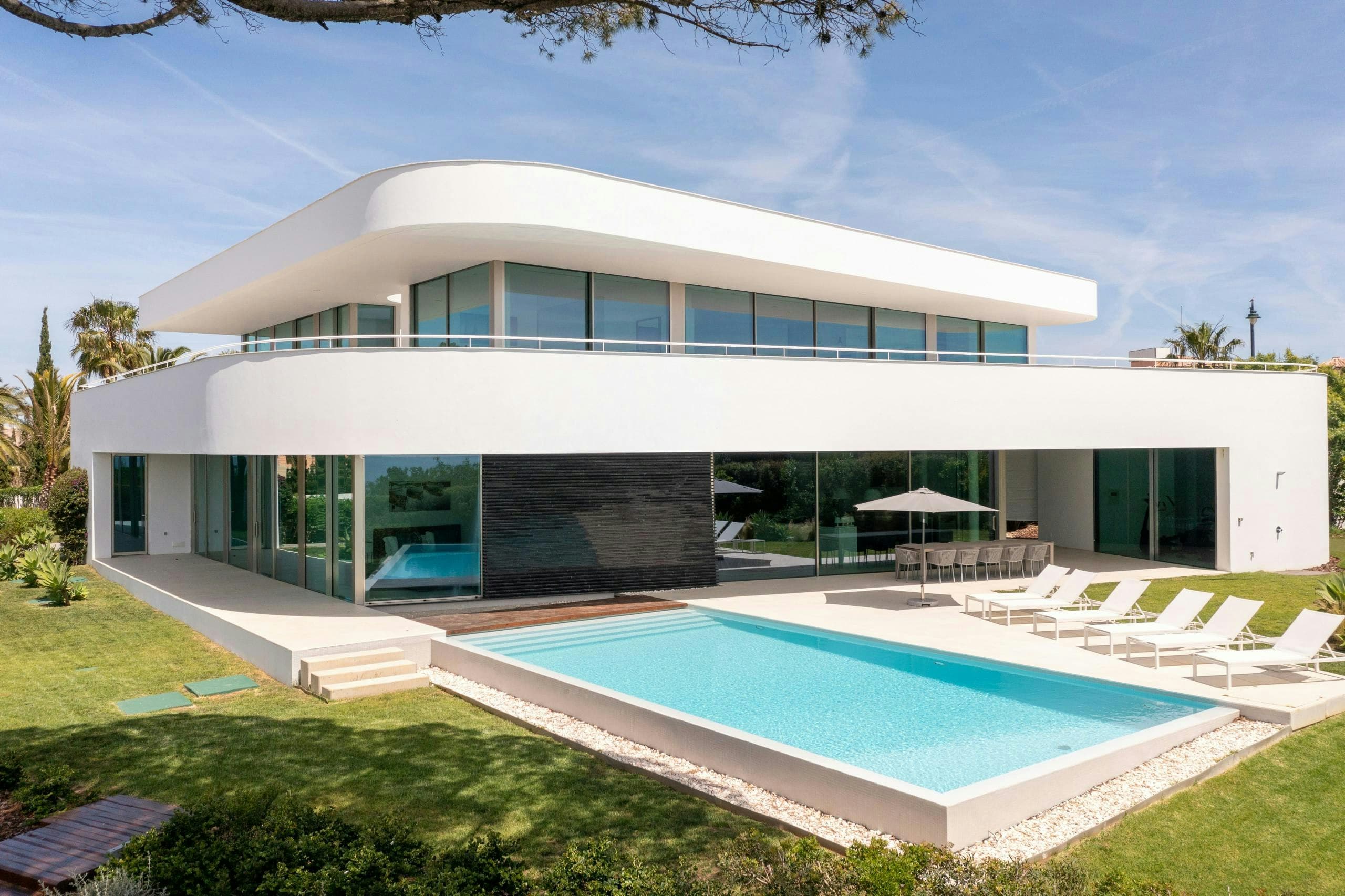 Atlantic Blues villa exterior with curved roof, infinity pool and Atlantic views, Lagos, Portugal