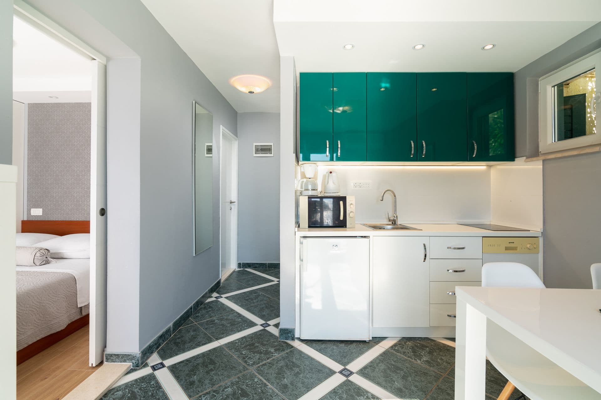 Double bedroom with a patterned grey feature wall at Blue All Around, Marina, Croatia