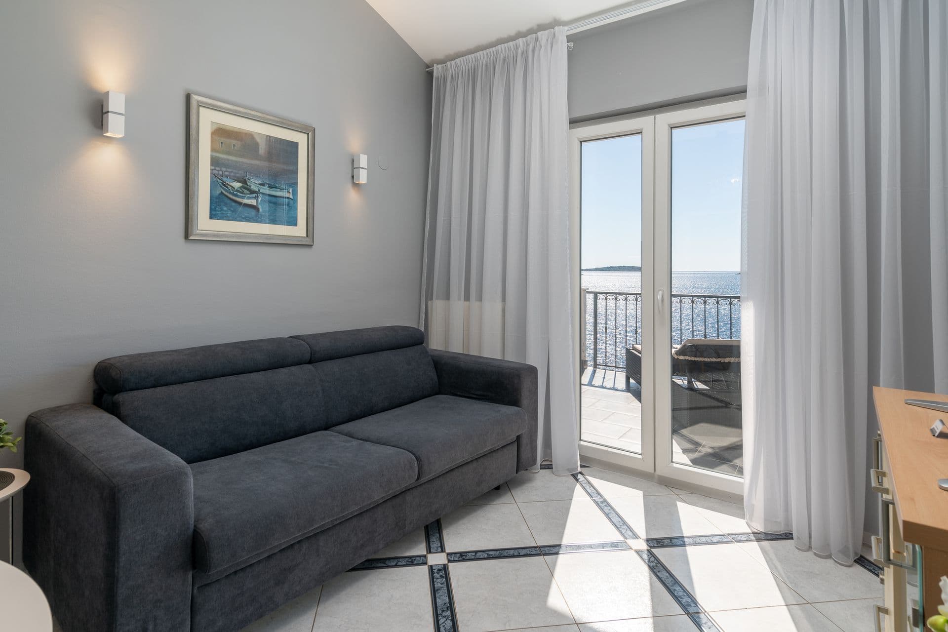 Studio living area with a sofa, kitchenette and dining table at Blue All Around, Marina, Croatia