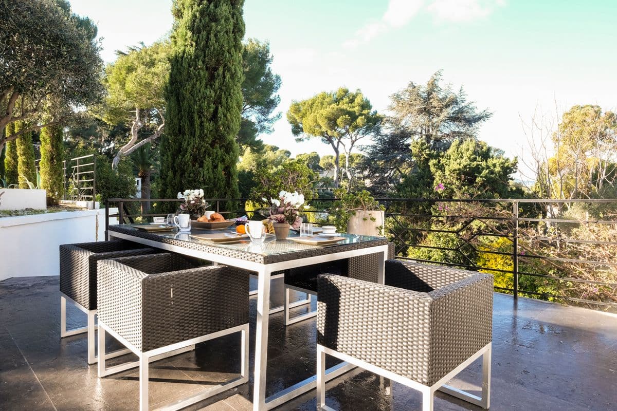 Terrace dining table and chairs overlooking landscaped gardens