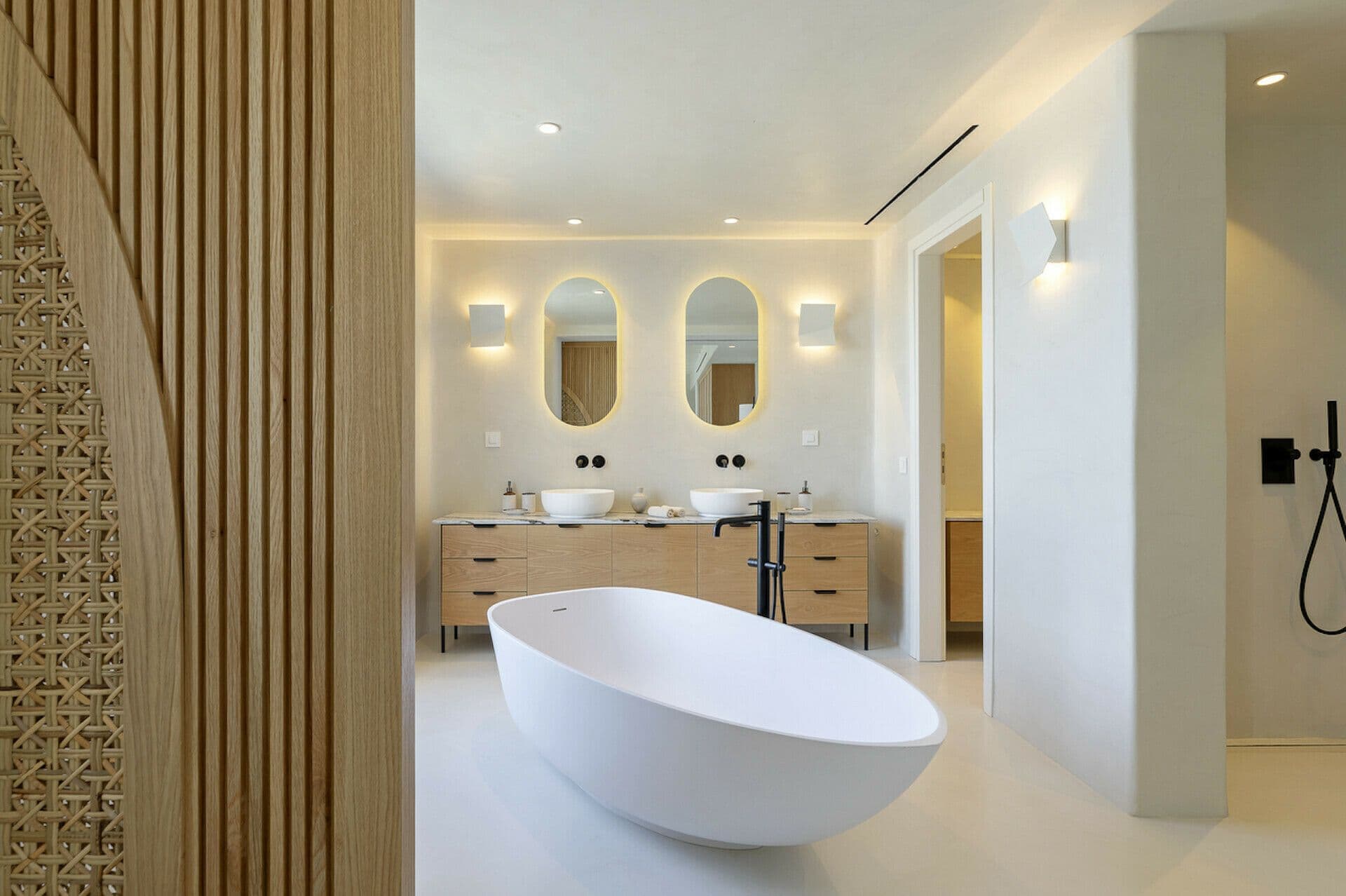 En-suite with a double vanity and a freestanding tub in an arched niche at Cycladic Wonder, Mykonos