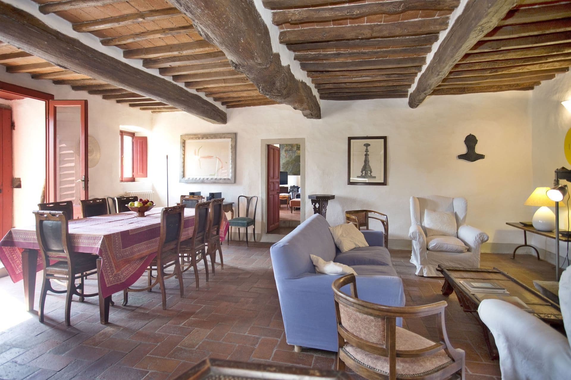 Combined dining and living room with terracotta floors at Picturesque Hideaway