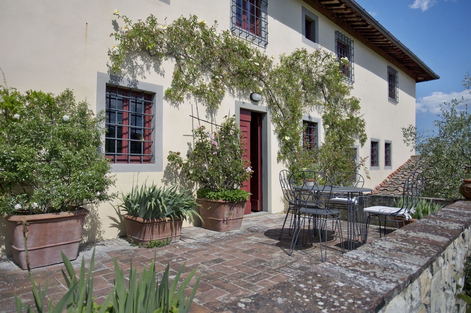 Stone farmhouse exterior with vine-covered patio at Picturesque Hideaway