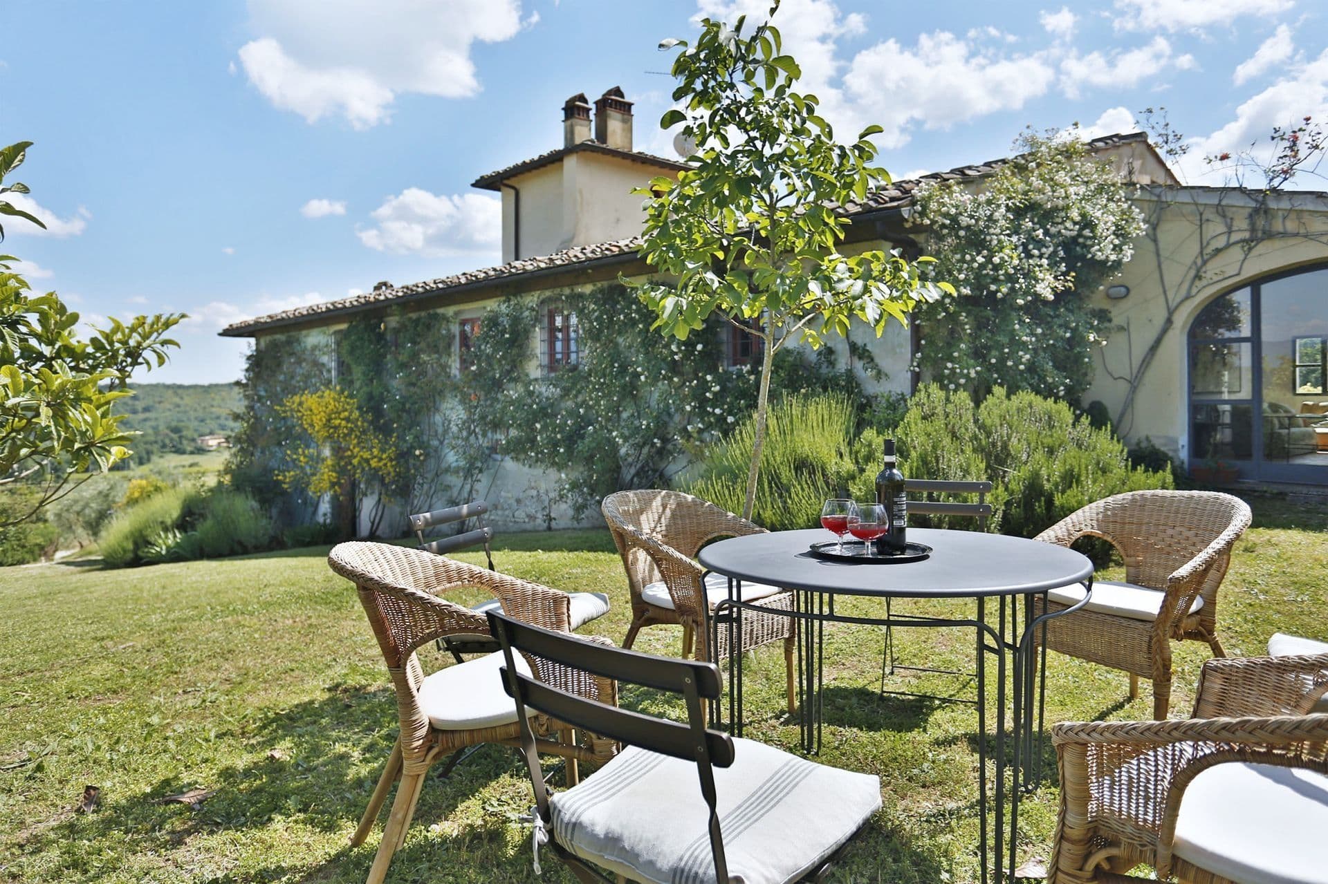 Outdoor dining table set in the garden overlooking Tuscan hills at Picturesque Hideaway