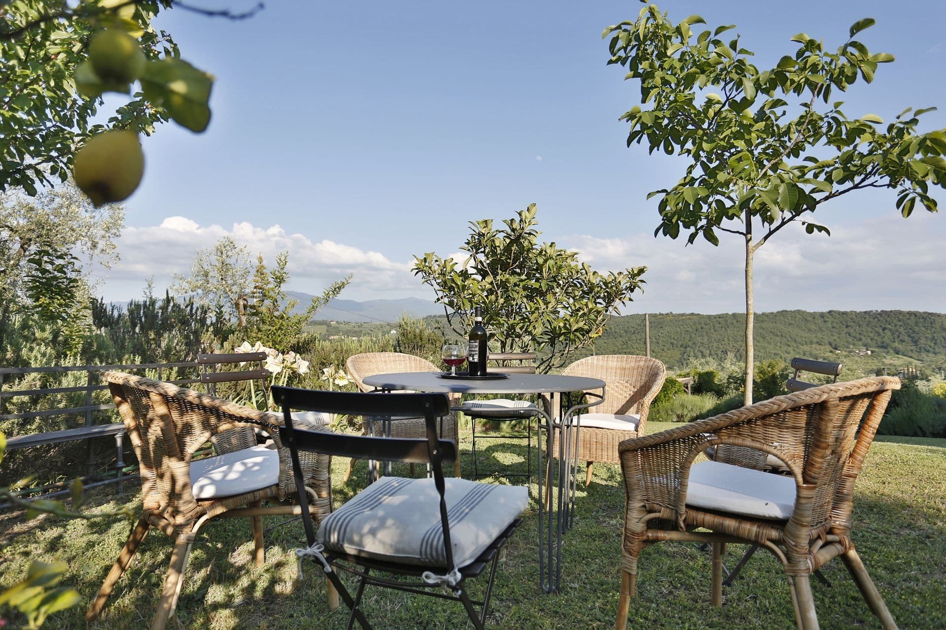 Garden seating area beneath fruit trees at Picturesque Hideaway