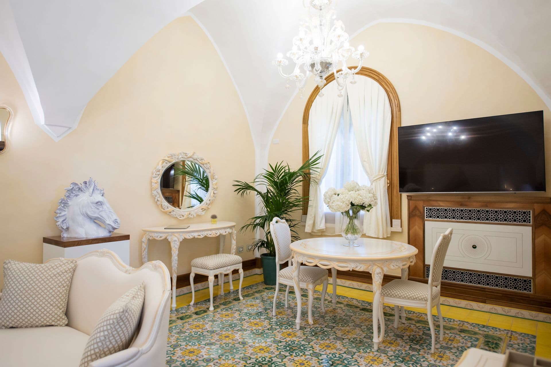 Fireside lounge with sea-view windows and antique seating