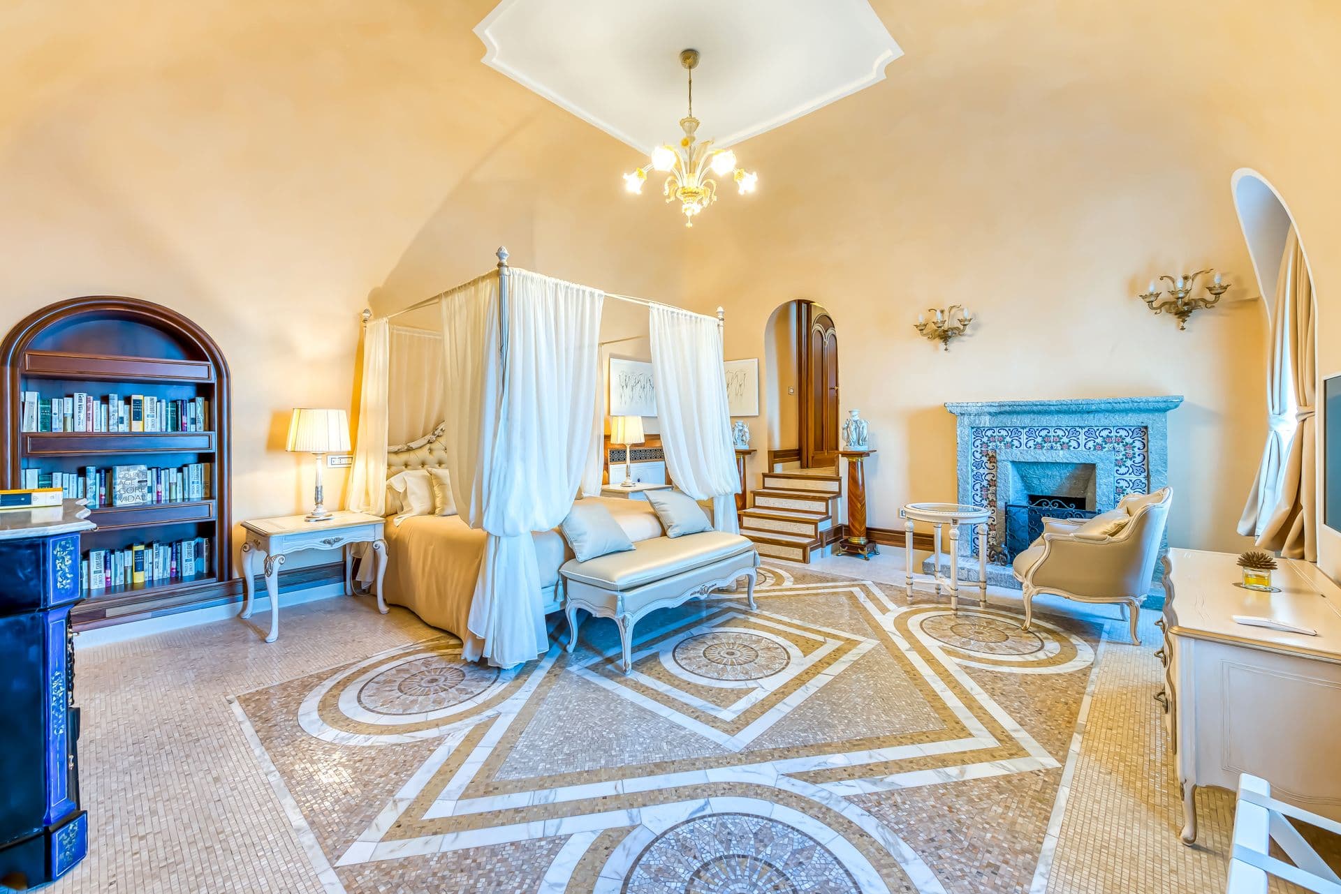 Master bedroom with four-poster bed and mosaic tiled floor