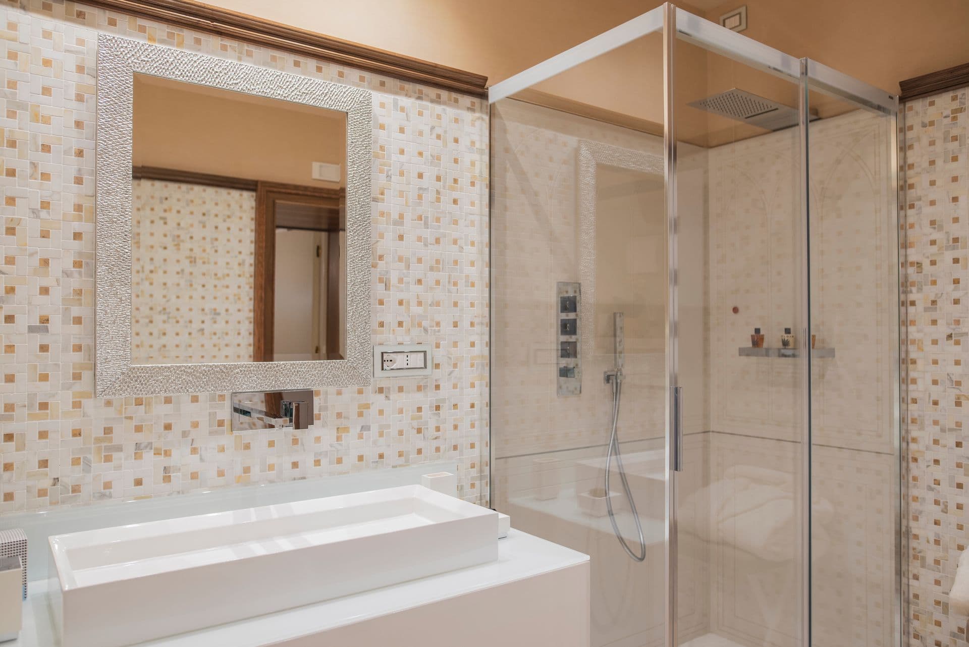 En-suite bathroom with mosaic tiling and glass walk-in shower