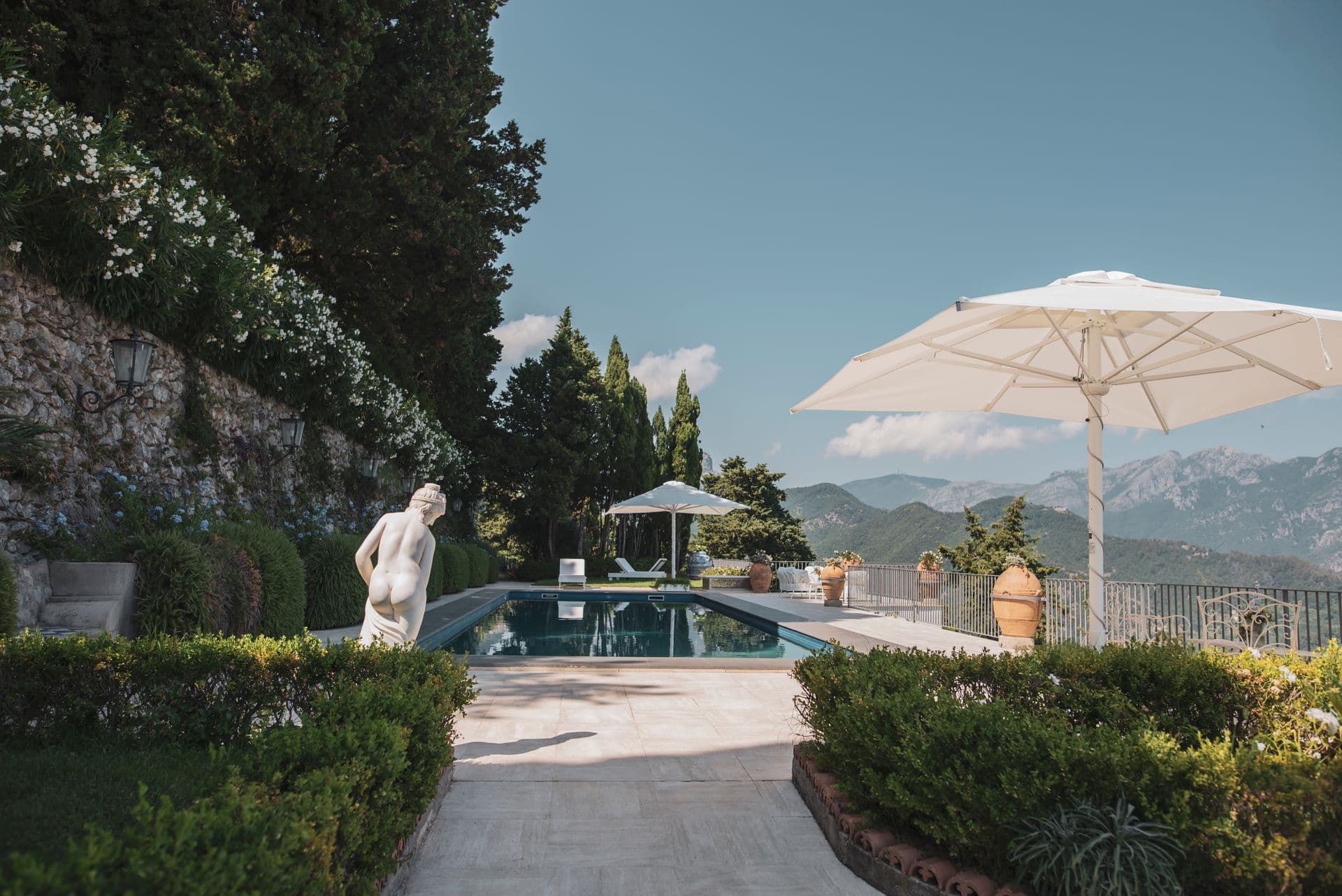 Landscaped garden and pool terrace with classical statue at The Enchanting Terrace