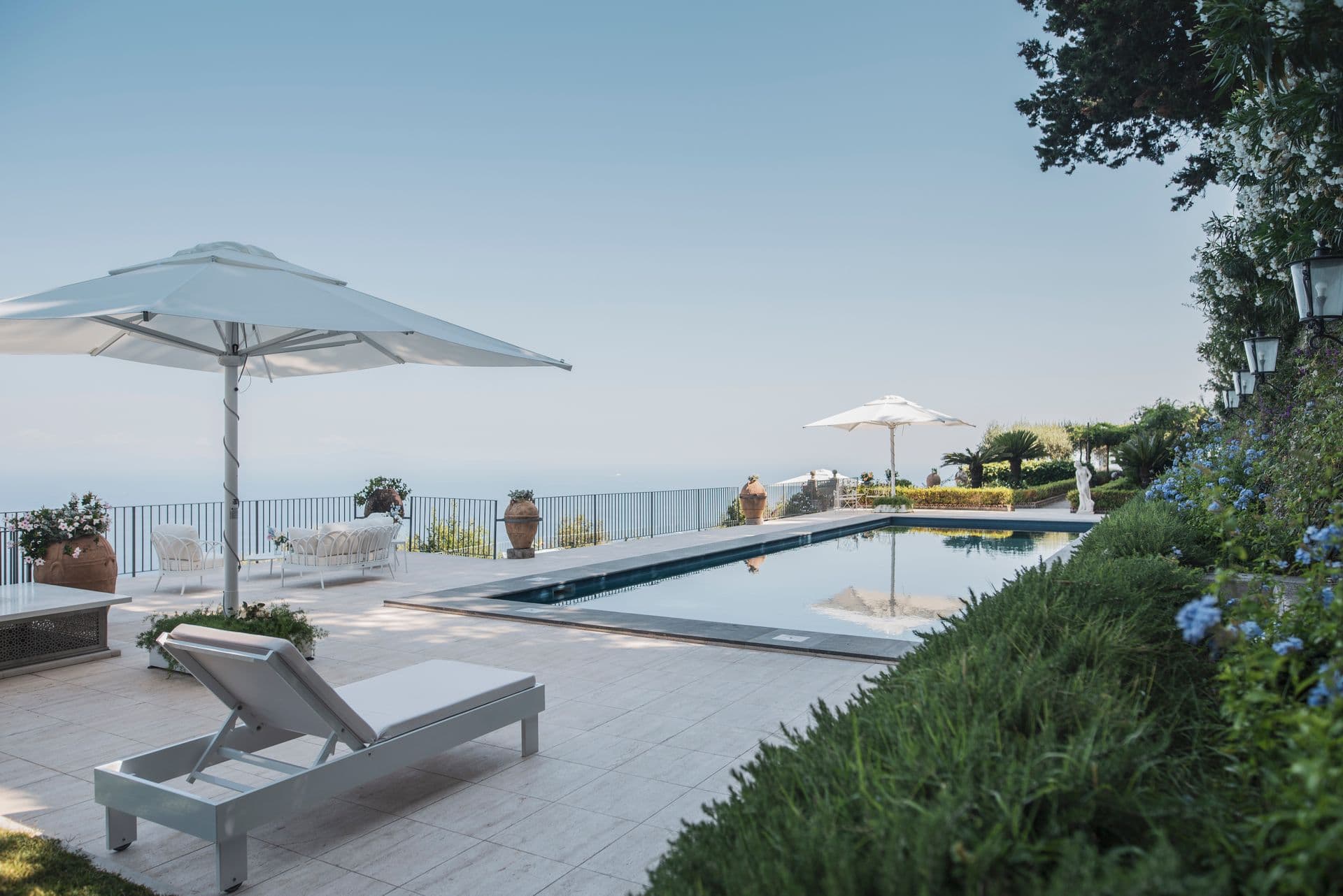 Pool terrace with sun loungers overlooking the Amalfi coastline