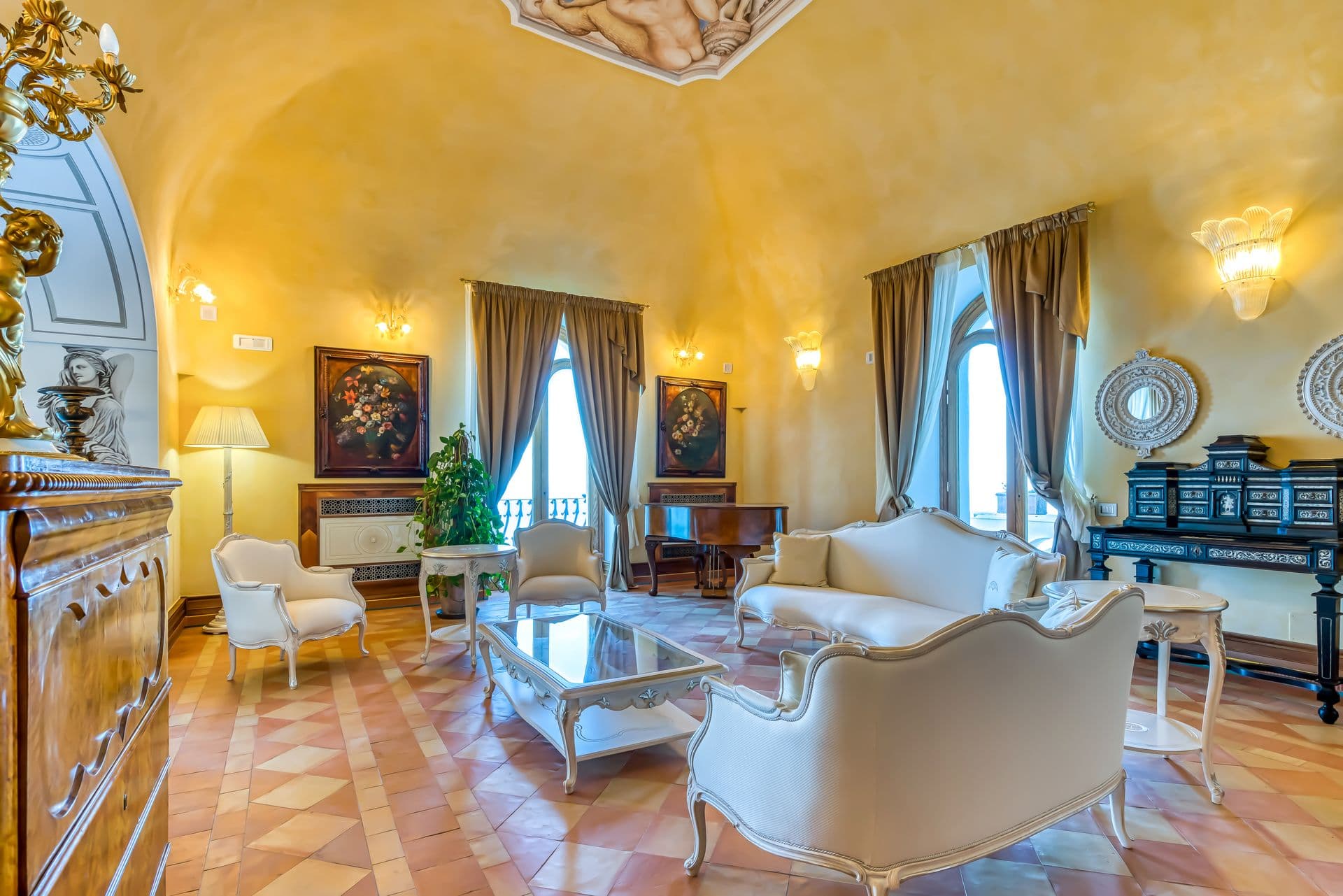 Vaulted reception hall with classical statuary and period furnishings