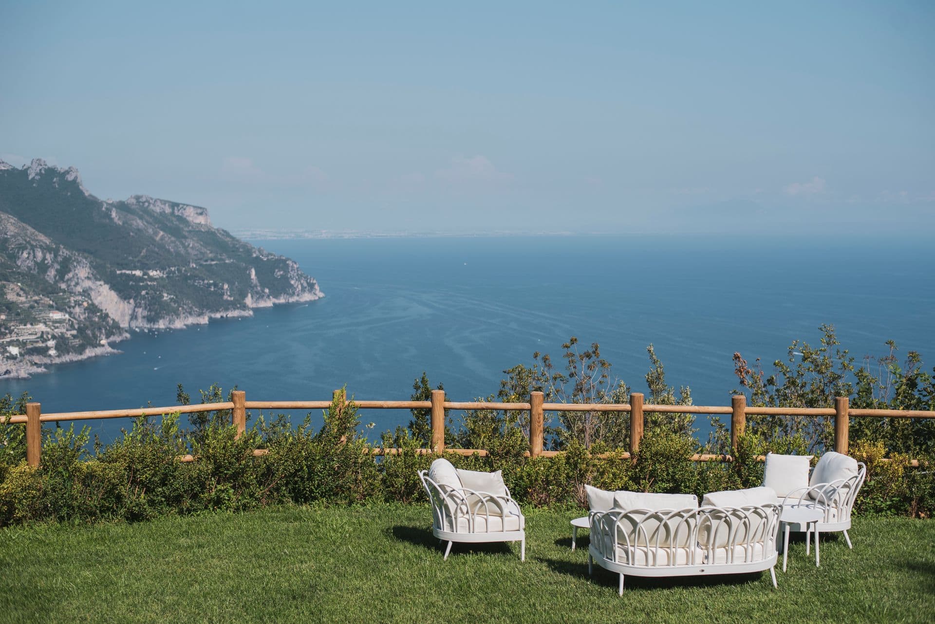 Manicured lawn with seating overlooking the sea from The Enchanting Terrace