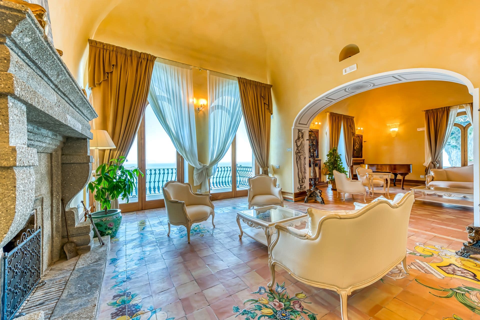 Sitting room with tiled floor and archway leading to further reception rooms