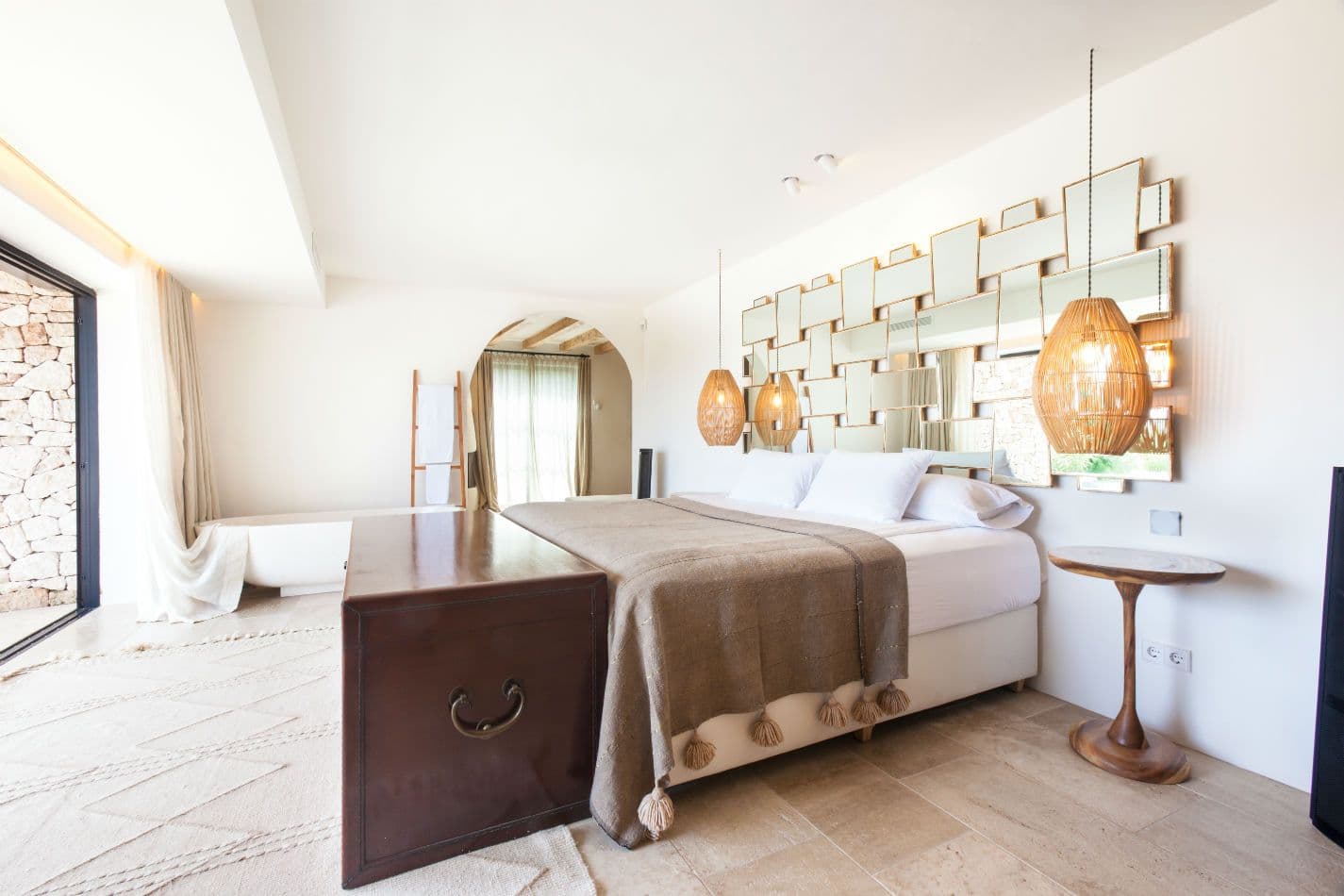 Bedroom with vaulted ceiling and neutral linen bedding