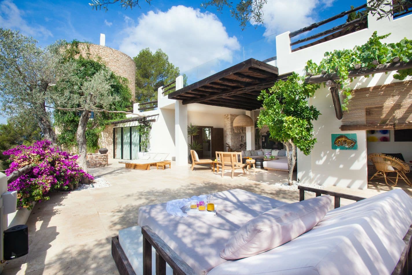 Shaded daybed terrace framed by bougainvillea in full bloom