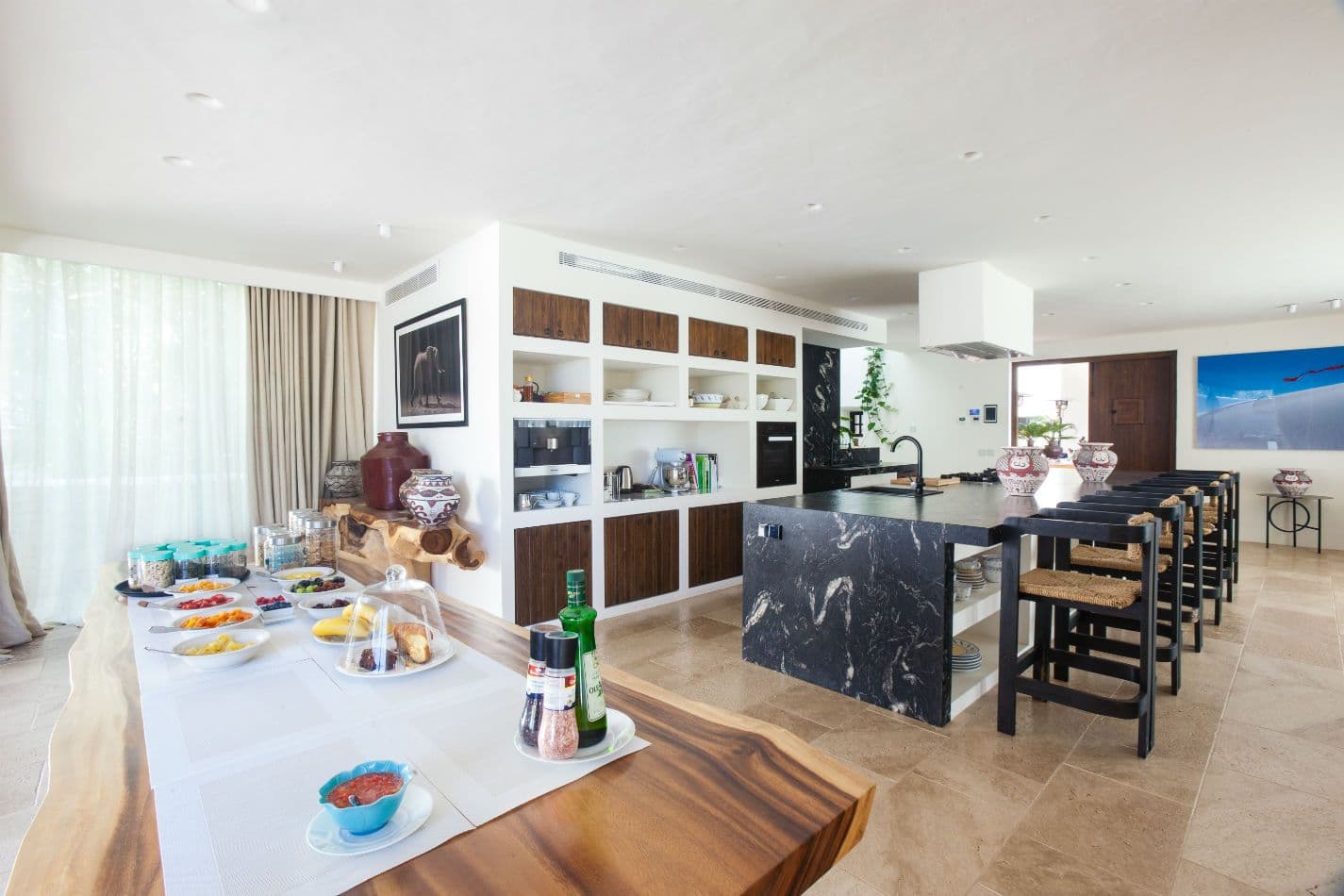 Kitchen with black marble island and breakfast spread laid out
