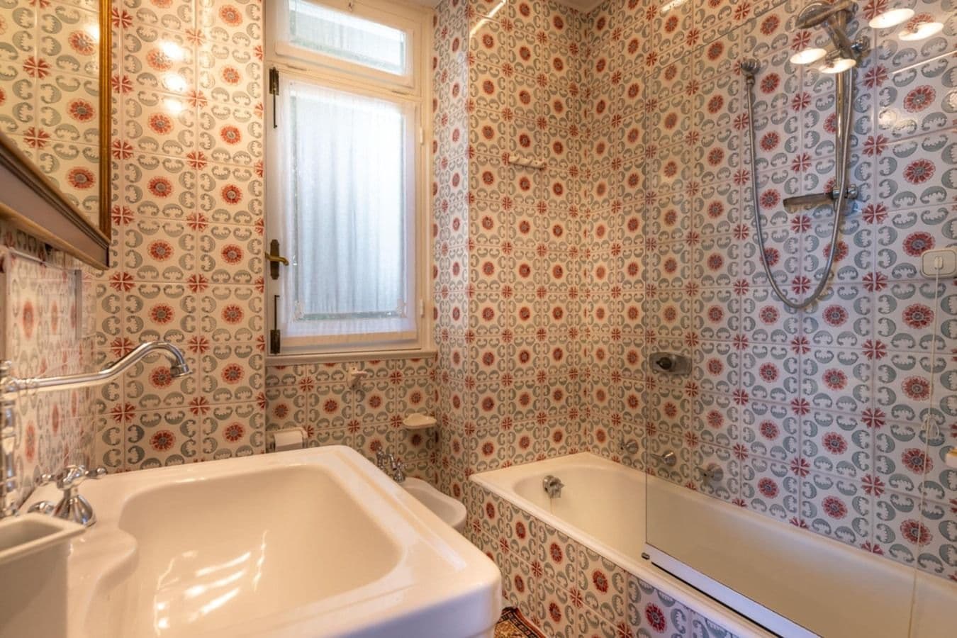 Bathroom with patterned tiles and freestanding tub at On the Emerald Coast, Rapallo