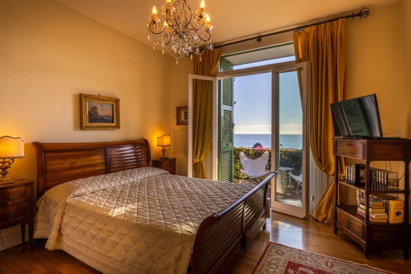 Bedroom with mustard curtains and sea view at On the Emerald Coast, Rapallo