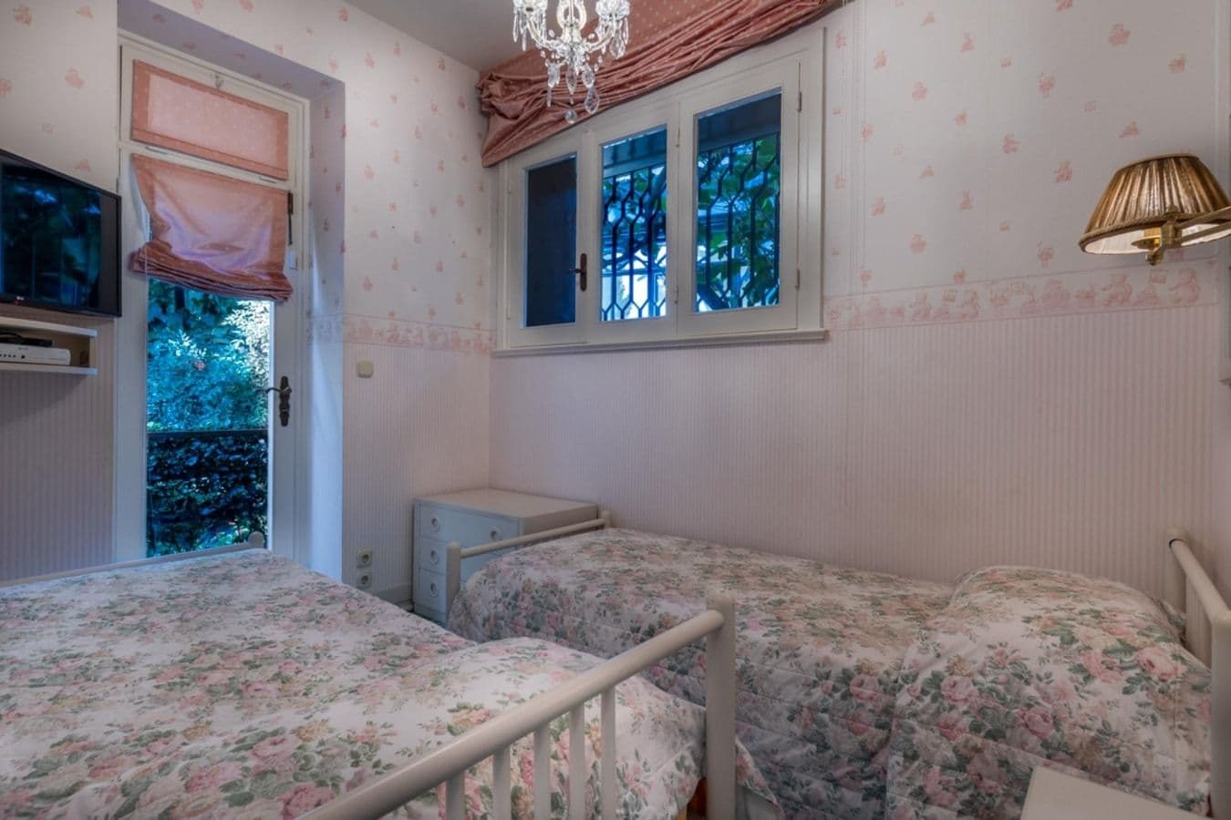 Twin bedroom with floral bedding at On the Emerald Coast, Rapallo