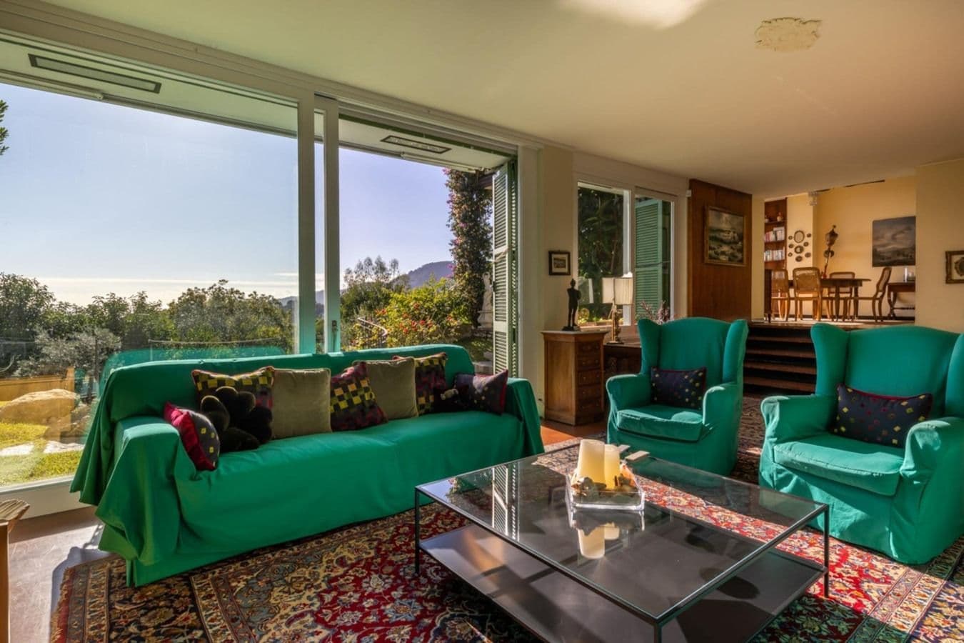 Living room with emerald green sofas and garden view at On the Emerald Coast, Rapallo