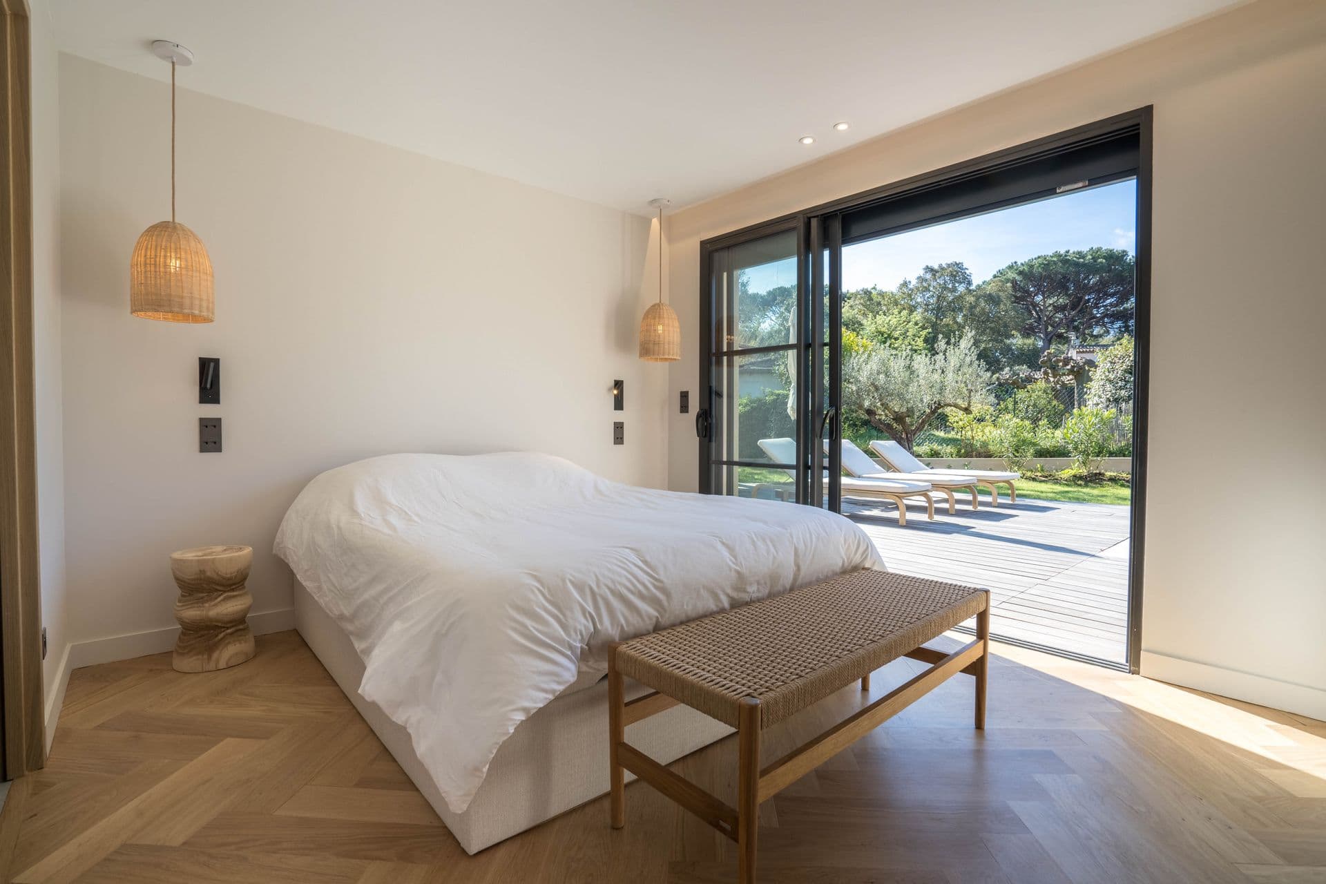Bedroom opening directly onto the garden terrace through sliding doors