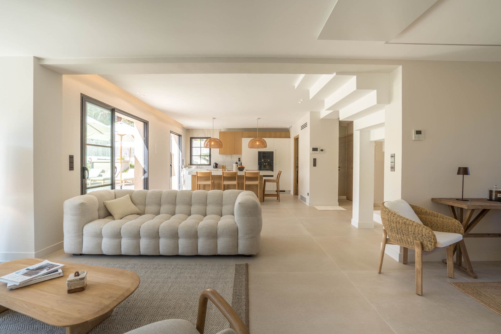 Open-plan living and dining space with vaulted ceiling and natural light
