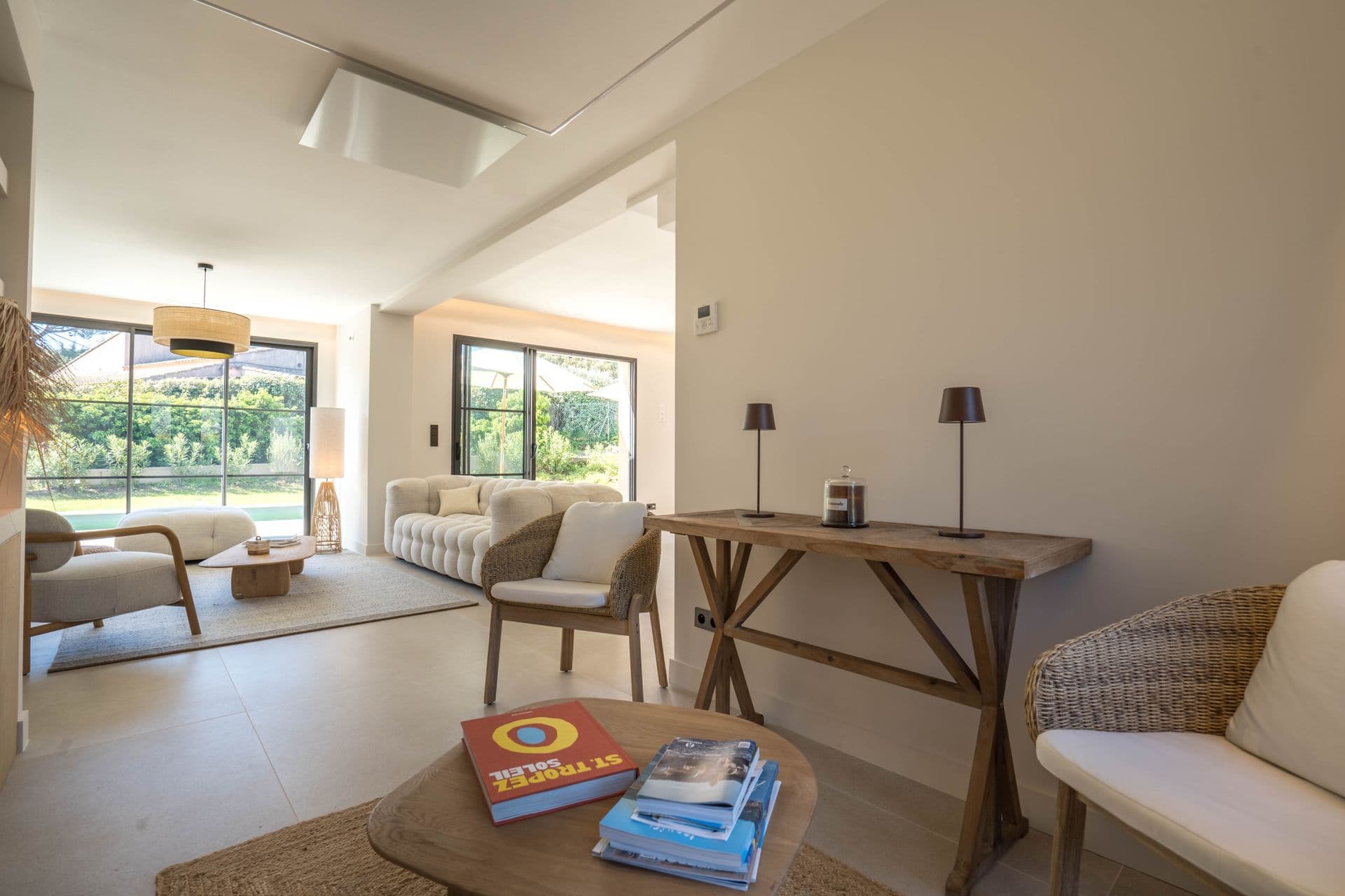 Second seating area with armchairs and a writing desk beside the garden doors