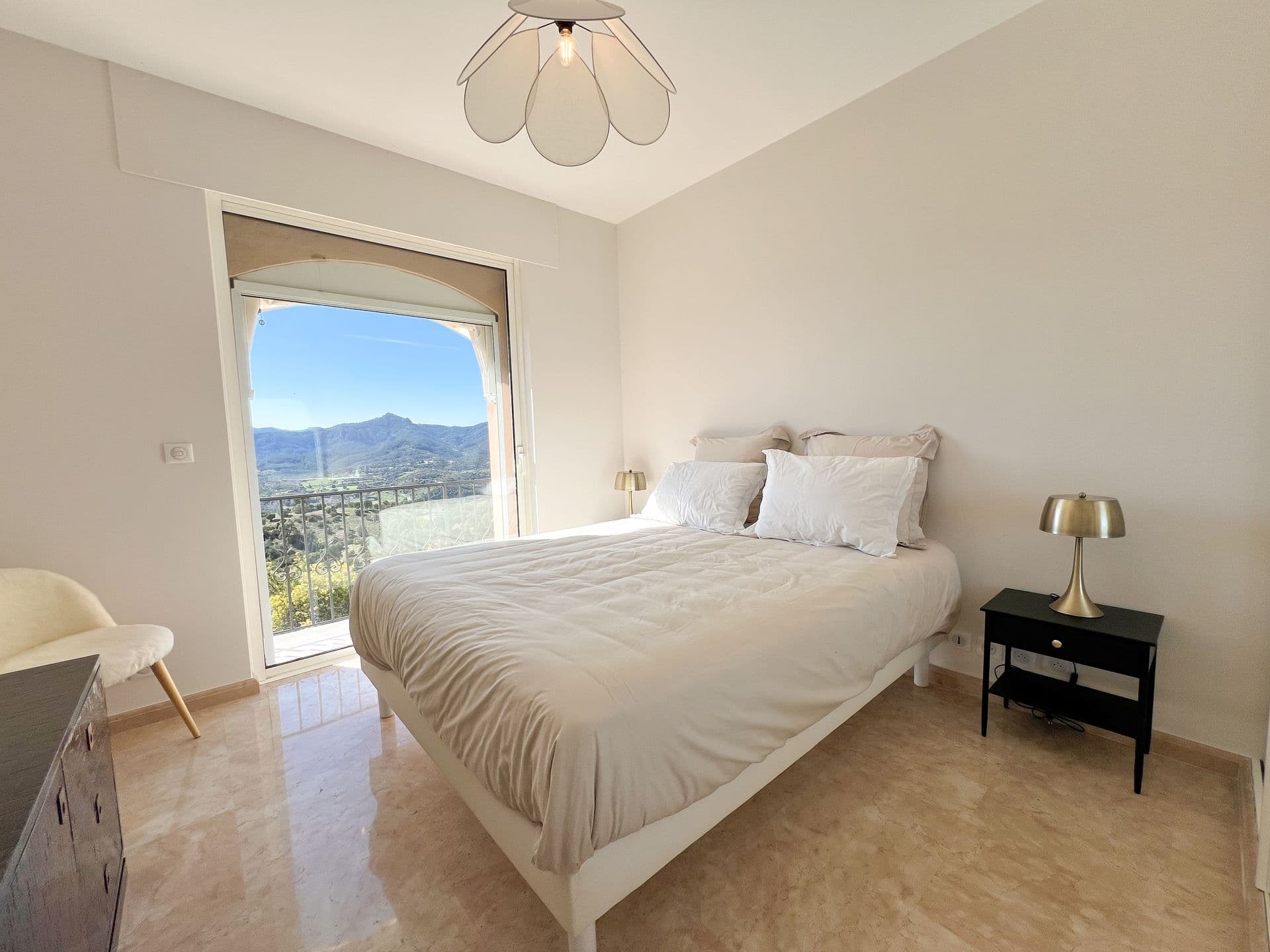 Guest bedroom with double bed and hillside view at Golden Escape