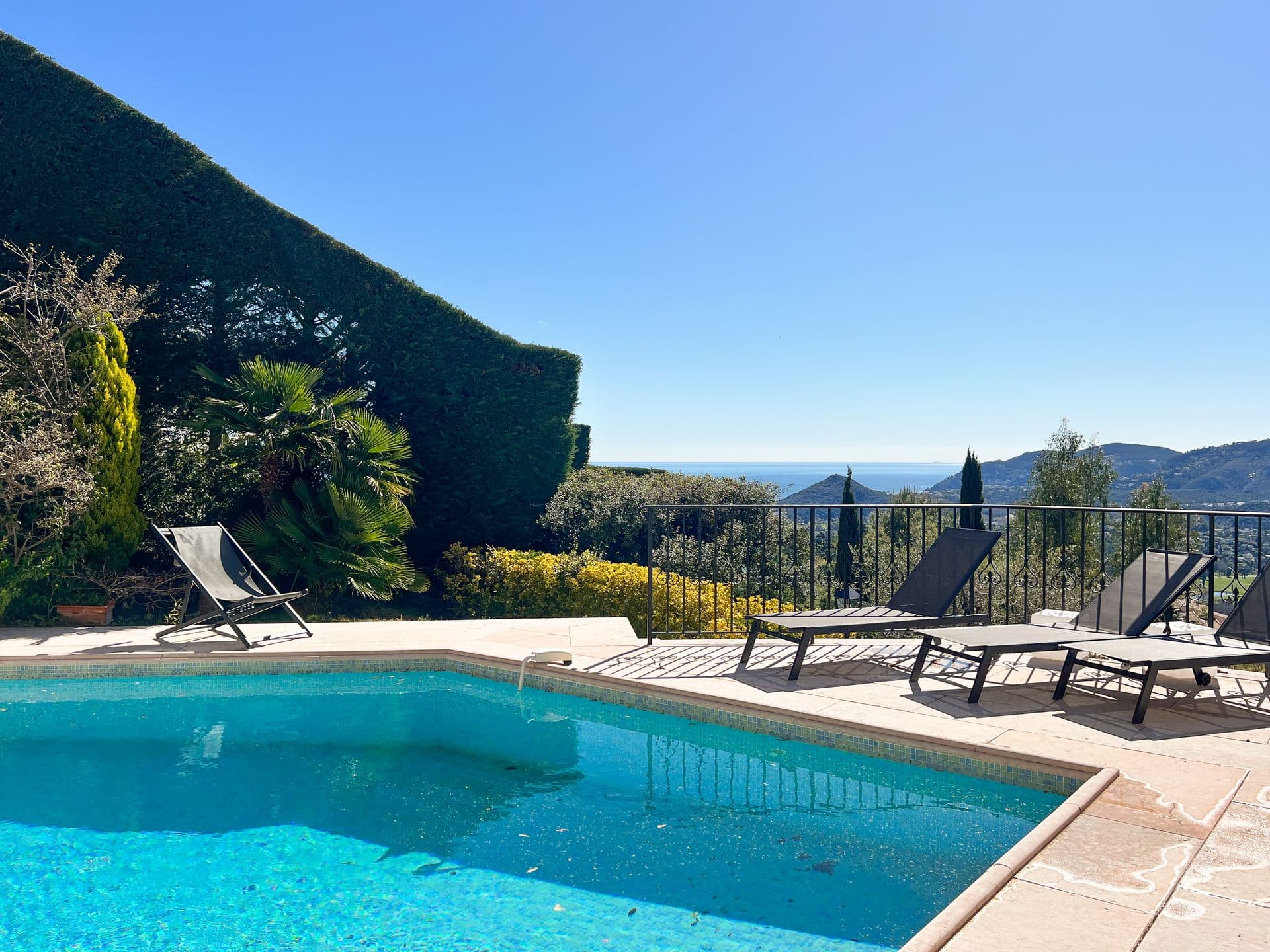 Turquoise swimming pool with sun loungers overlooking the Provencal hills at Golden Escape, Mandelieu-la-Napoule
