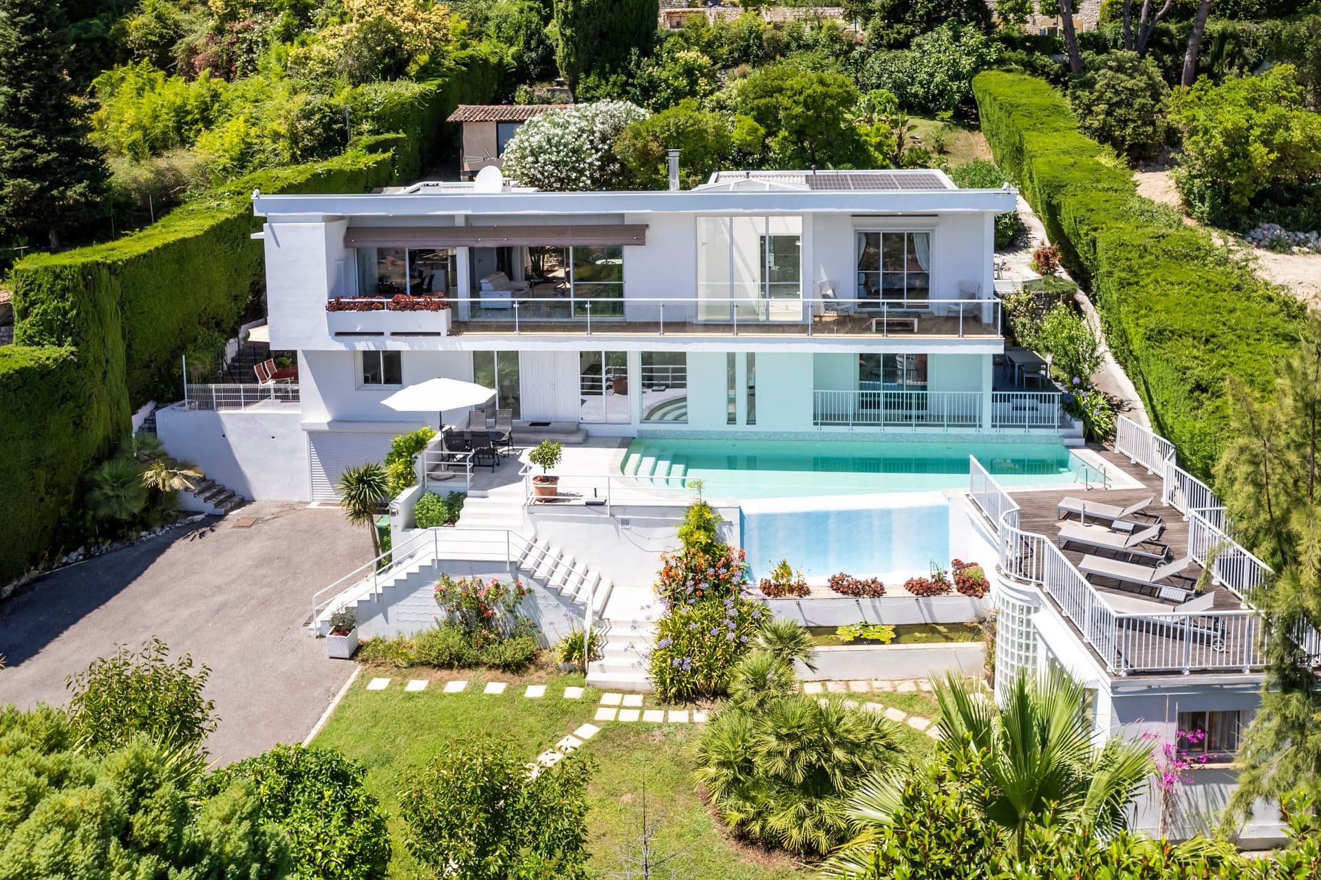 Aerial view of Olive and Sea villa and pool set among Riviera hillside gardens