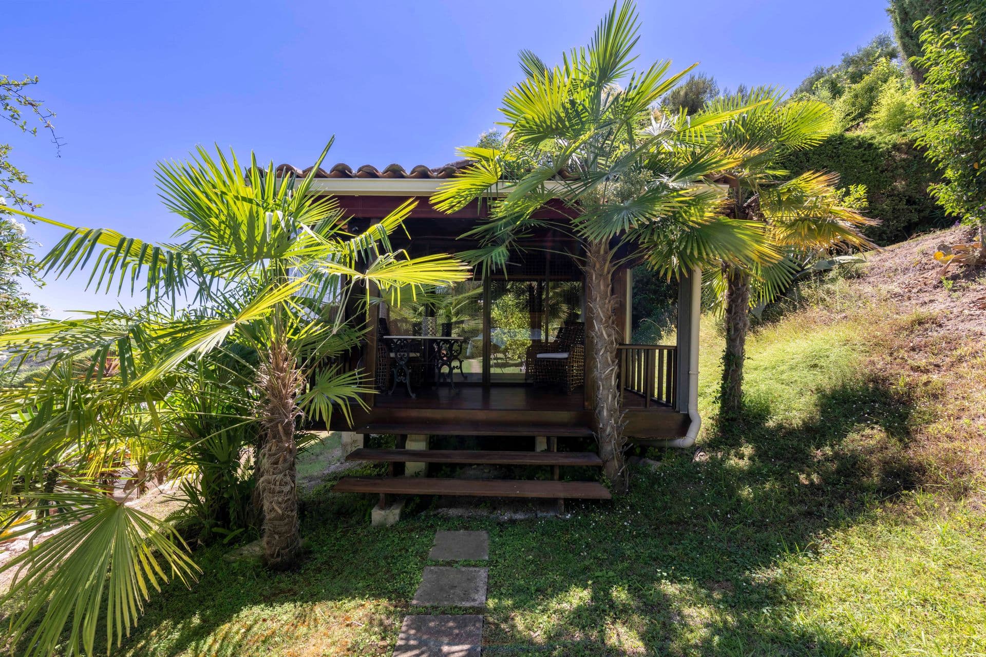 Palm-shaded garden and pergola at Olive and Sea, La Colle-sur-Loup