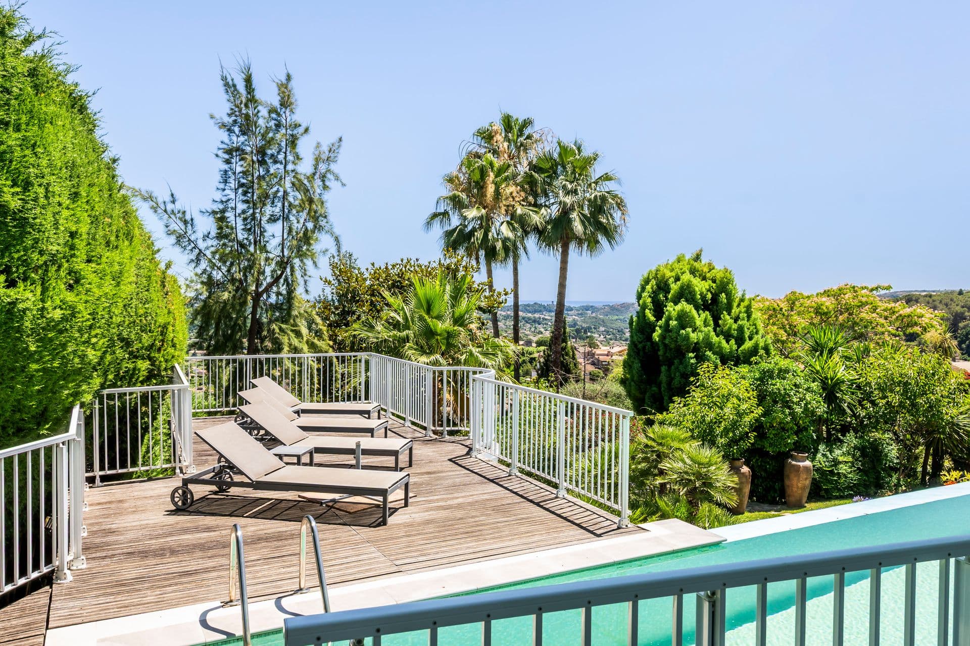 Pool deck with sun loungers and countryside views at Olive and Sea