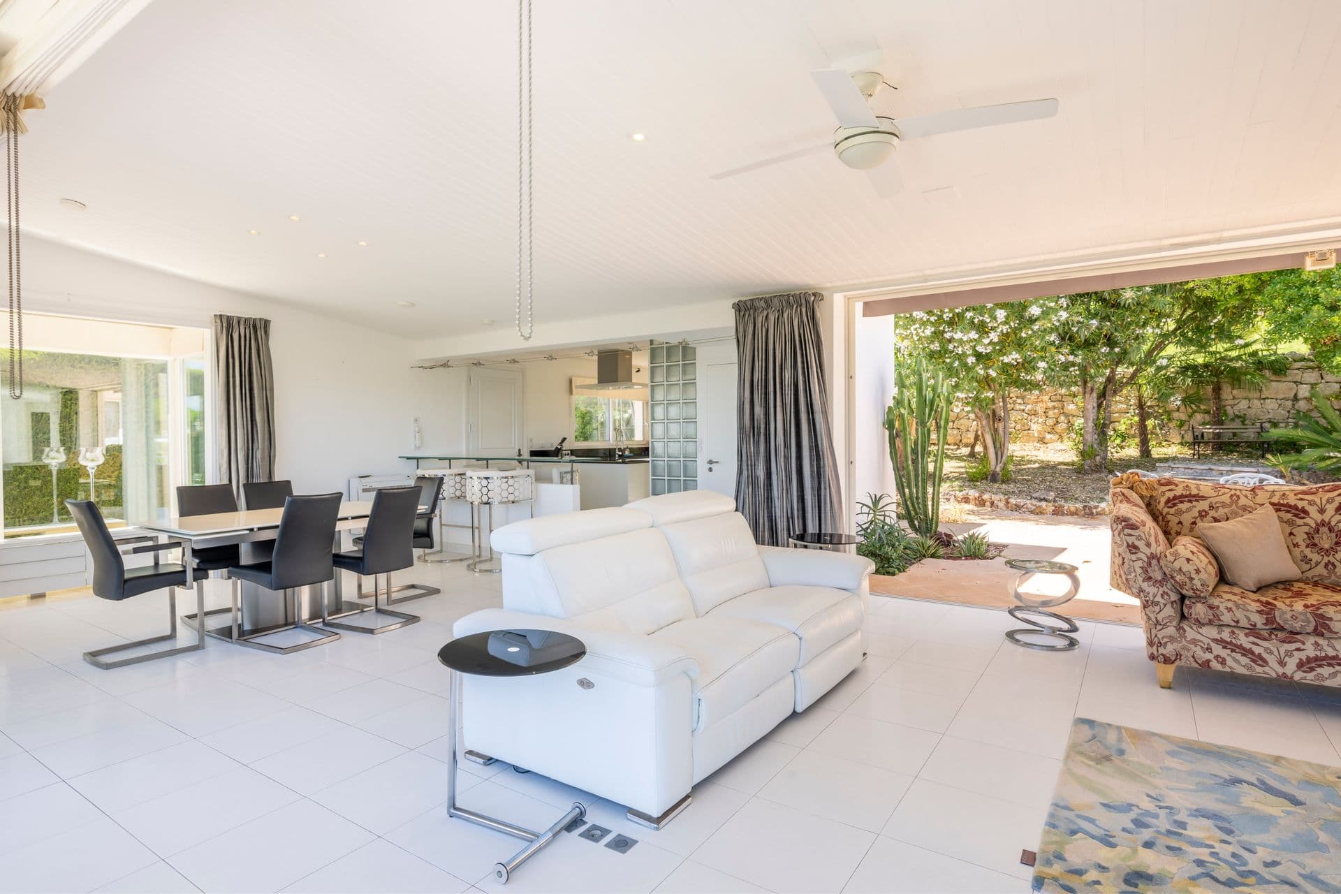 Open-plan living and dining area opening to the terrace at Olive and Sea