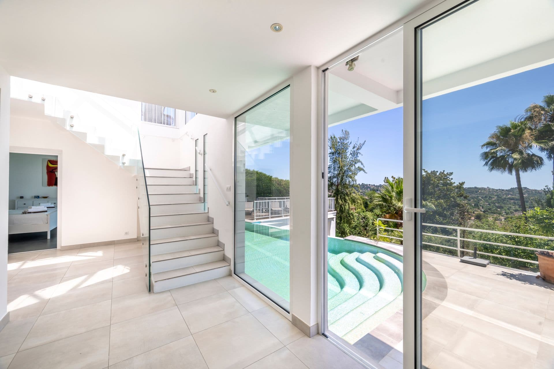 Staircase overlooking the pool and hillside view at Olive and Sea