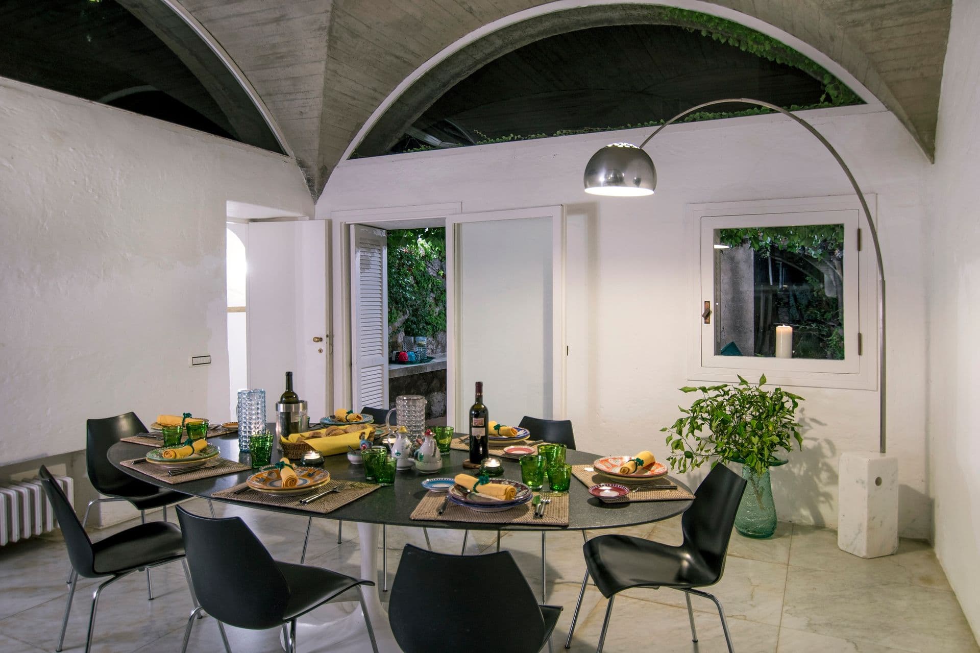 Modern dining room with dark table and chairs set for a meal