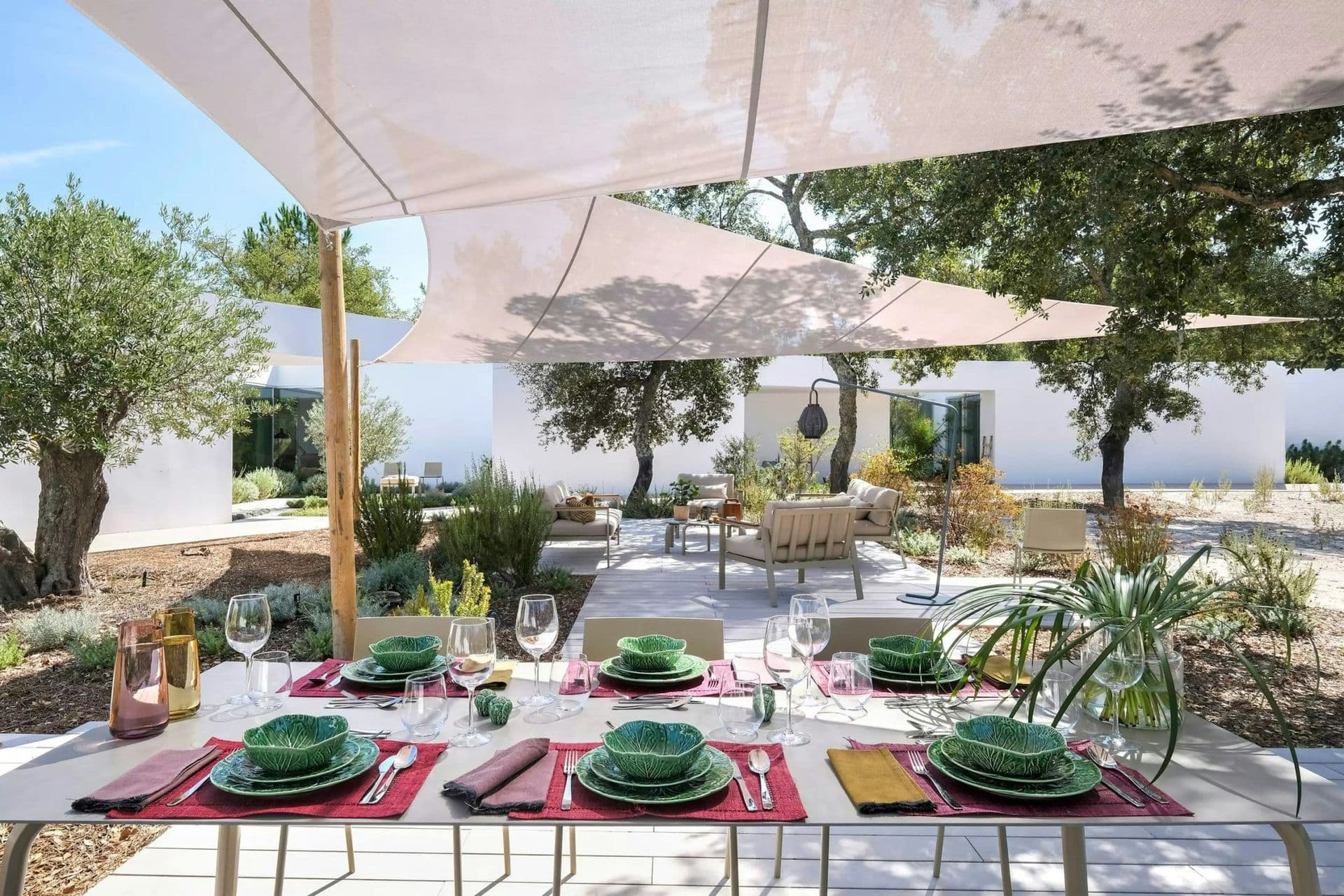 Timber deck with lounge seating under a cork oak at The Spirit of Joy, Comporta