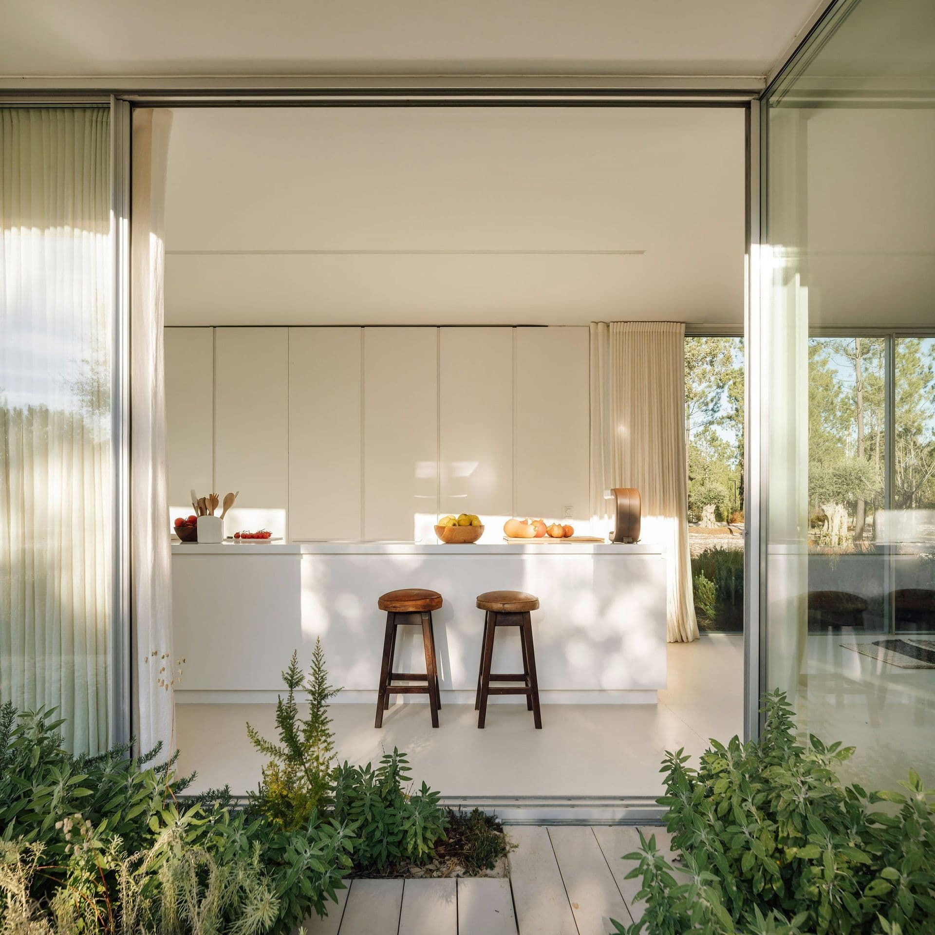 Kitchen opening to a planted courtyard at The Spirit of Joy, Comporta