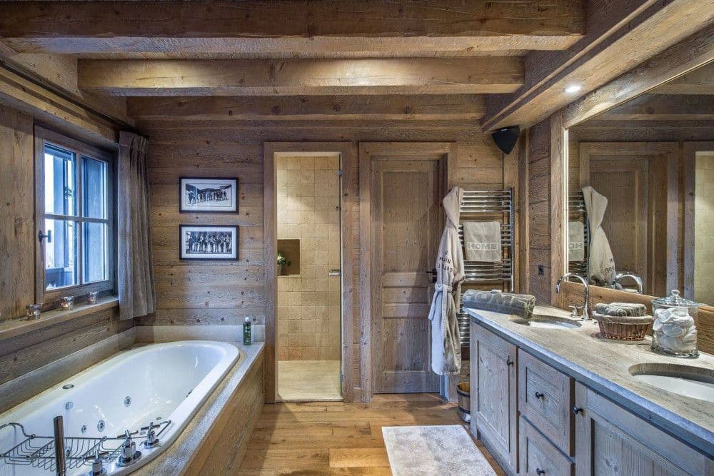En-suite bathroom with a bath and twin vanity at Meribel 139