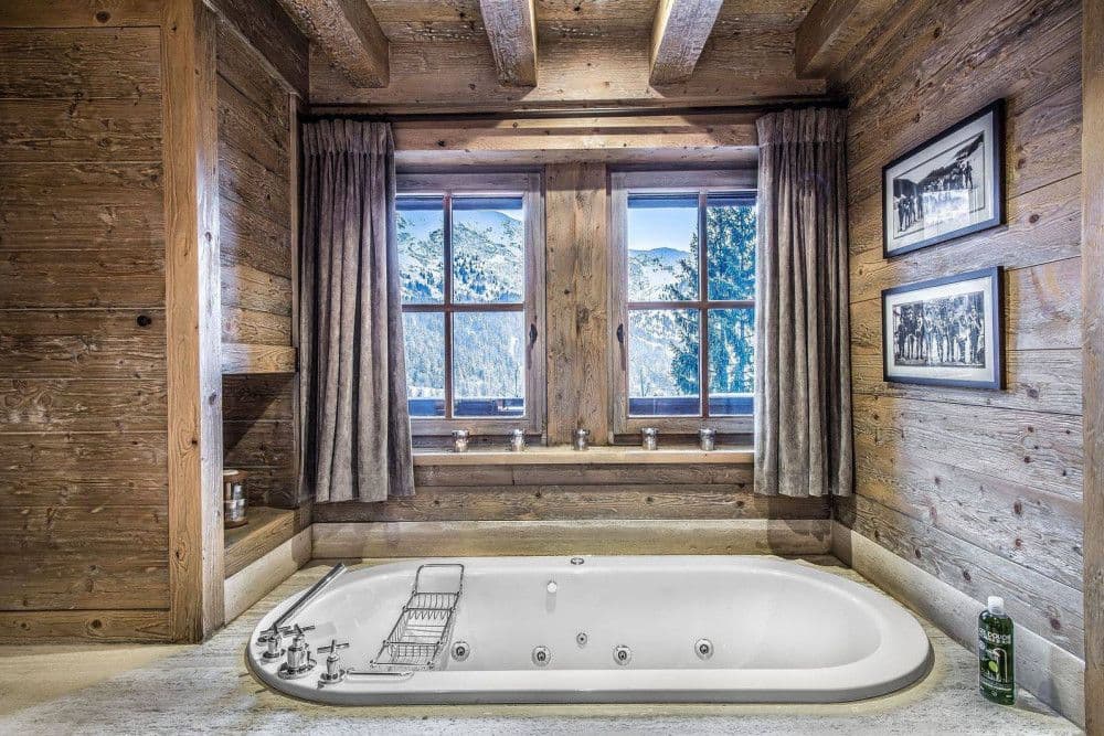 Jetted bath set beneath a mountain window at Meribel 139
