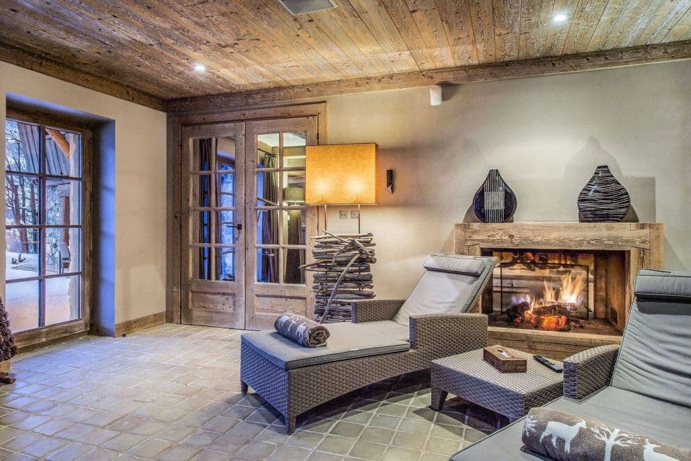 Relaxation lounge with a fire beside the indoor pool at Meribel 139