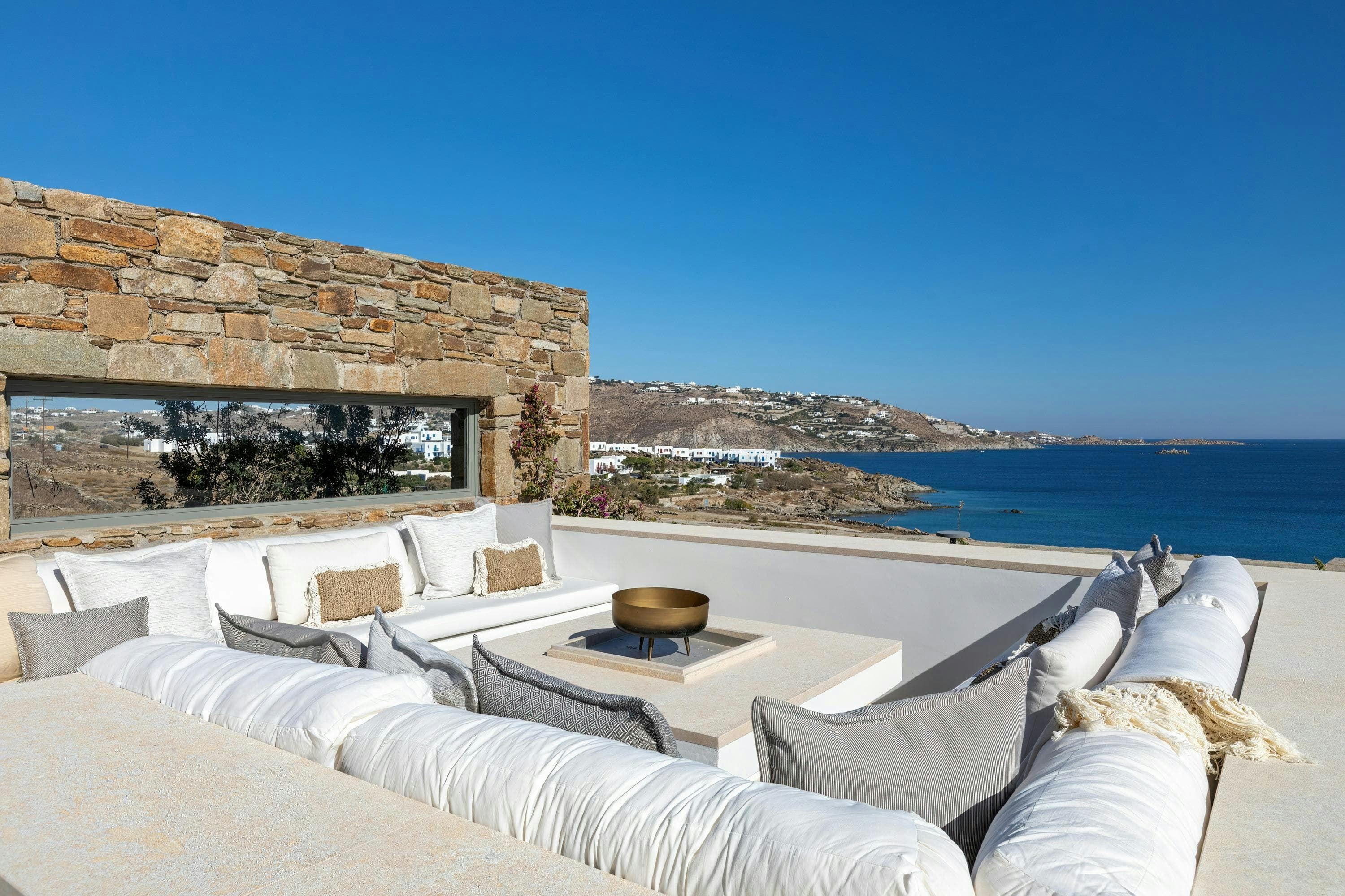 Golden Tide Houses outdoor terrace lounge with coastal views, Agios Ioannis, Cyclades Islands