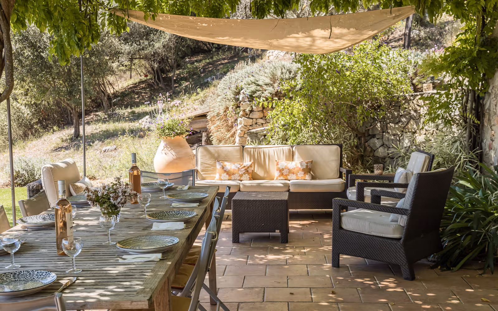 Shaded garden lounge with a sofa and armchairs among greenery at Choral Words, Var, Provence
