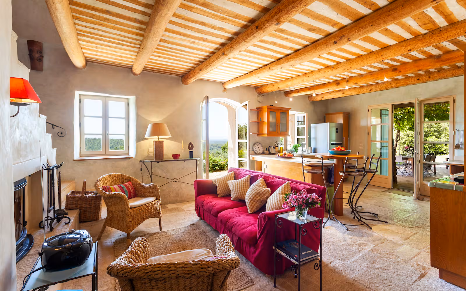 Beamed living room with a fuchsia sofa, fireplace and stone staircase at Choral Words, Var, Provence