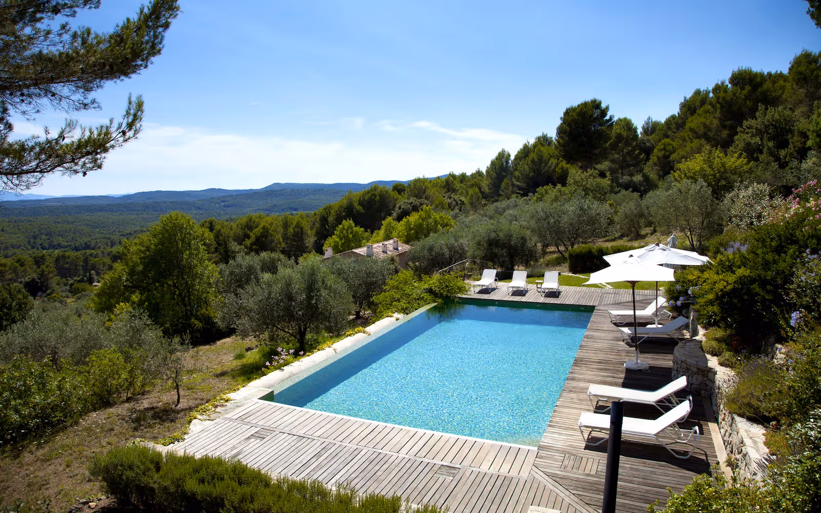 Pool and sun deck looking over an olive grove to the hills at Choral Words, Var, Provence